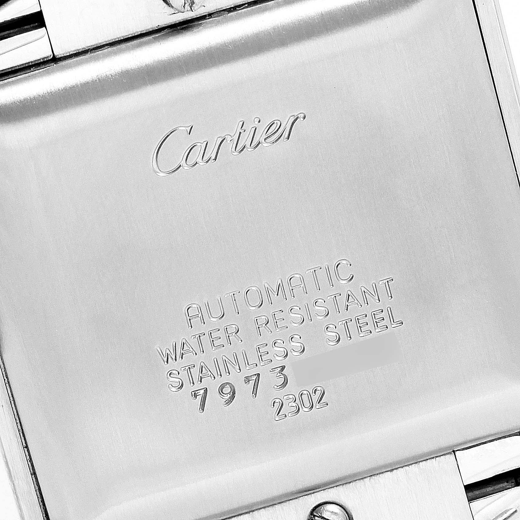 The image shows the stainless steel back casing of a Cartier Tank Française watch, displaying its engraved details.