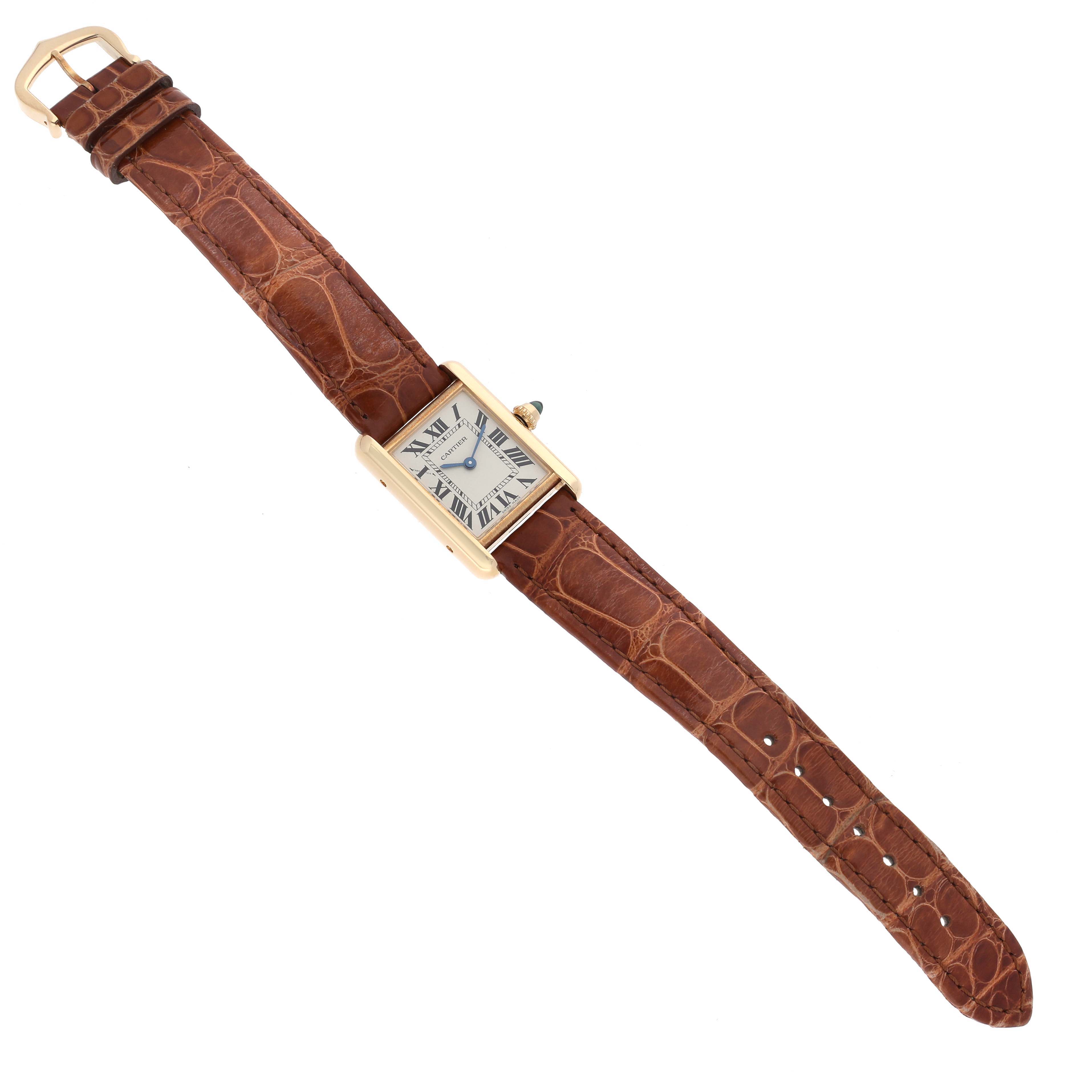 The Cartier Tank Louis W1529856 Women's Yellow Gold Silver Dial W1529856 Women's Yellow Gold Silver Dial watch is displayed flat, showcasing its rectangular face, brown leather strap, and gold buckle.