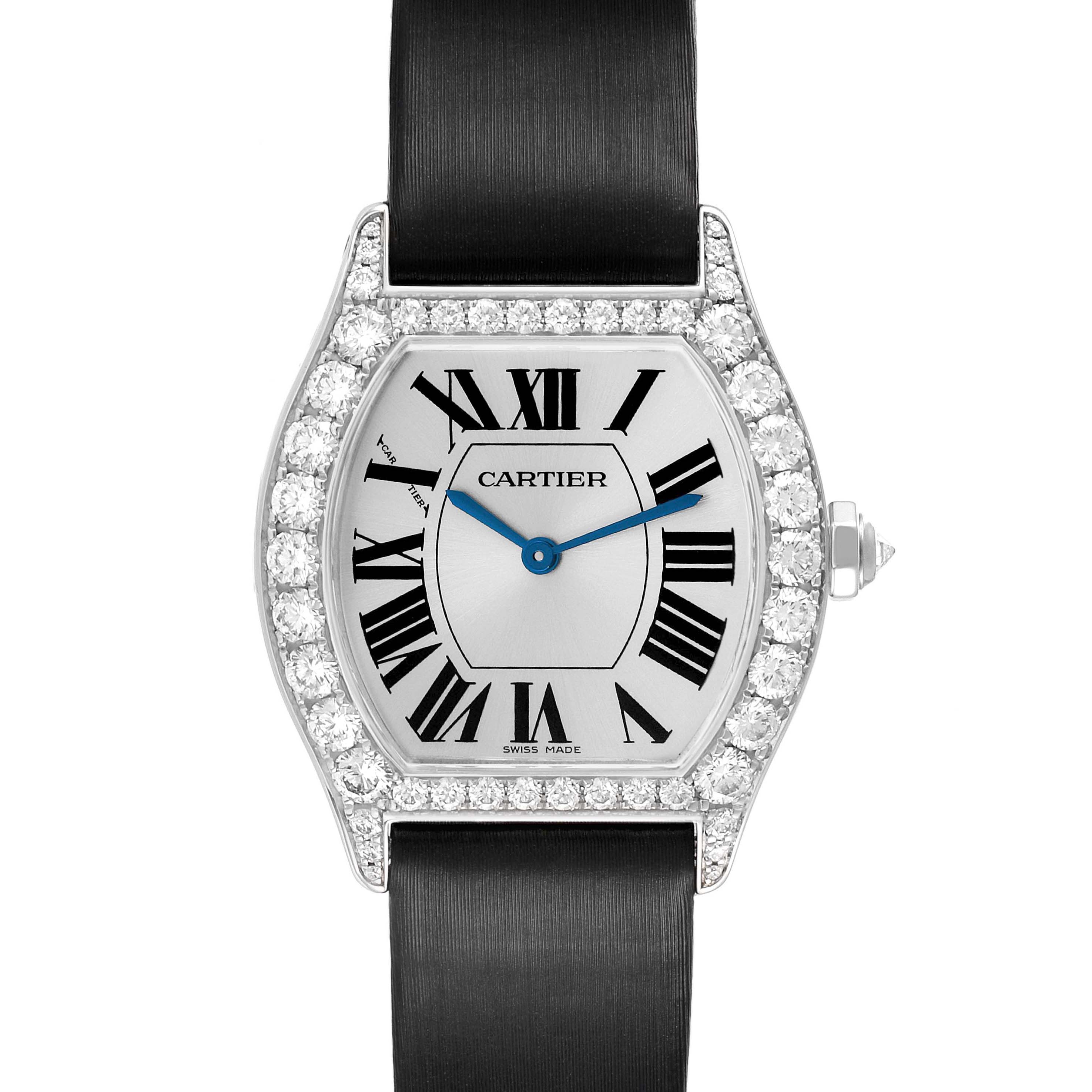 The Cartier Tortue WA507231 Women's White Gold Silver Dial watch is shown from a front view, featuring a diamond-encrusted bezel, Roman numerals, and black strap.