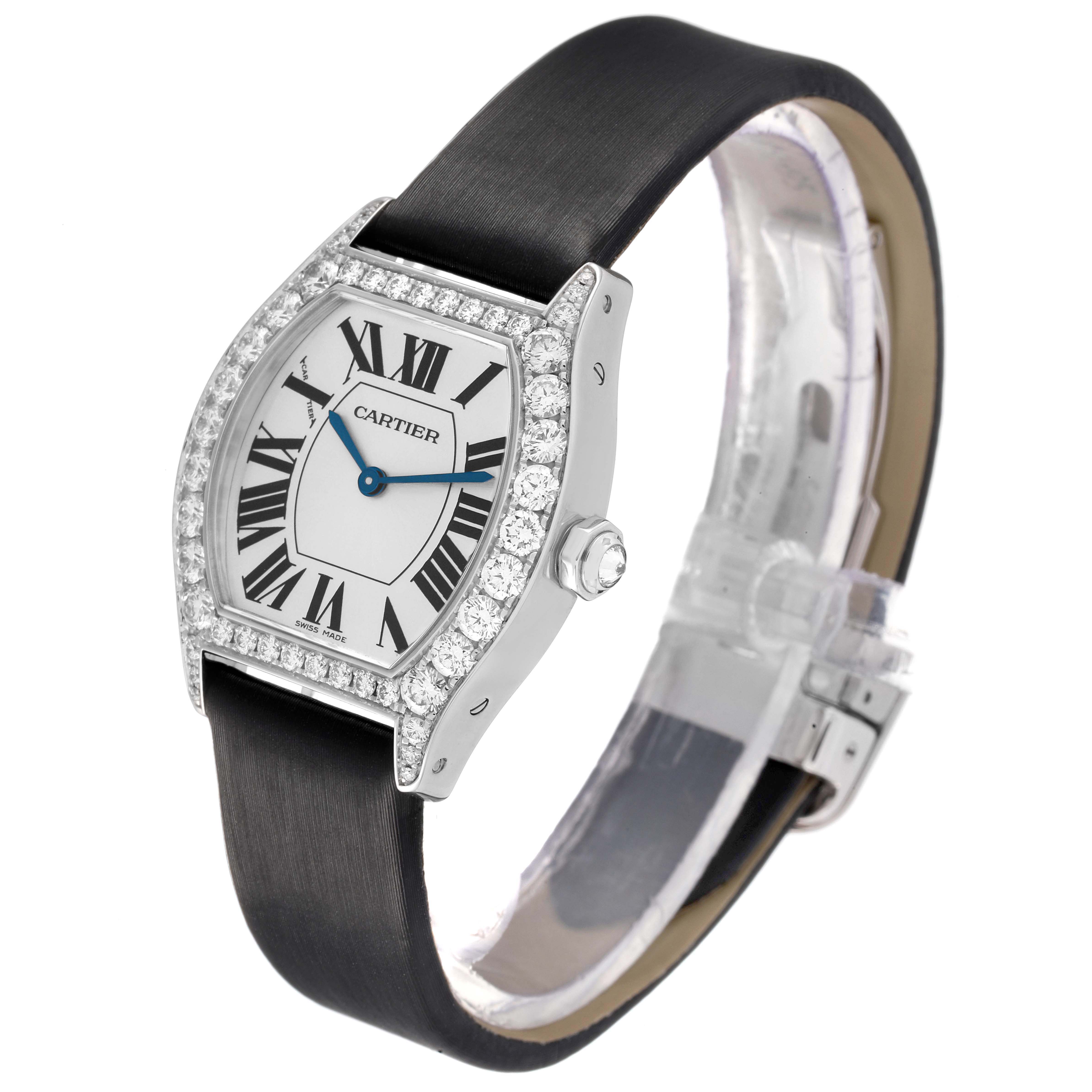 The Cartier Tortue WA507231 Women's White Gold Silver Dial watch is shown at a three-quarters angle, highlighting the case, bezel, and strap.