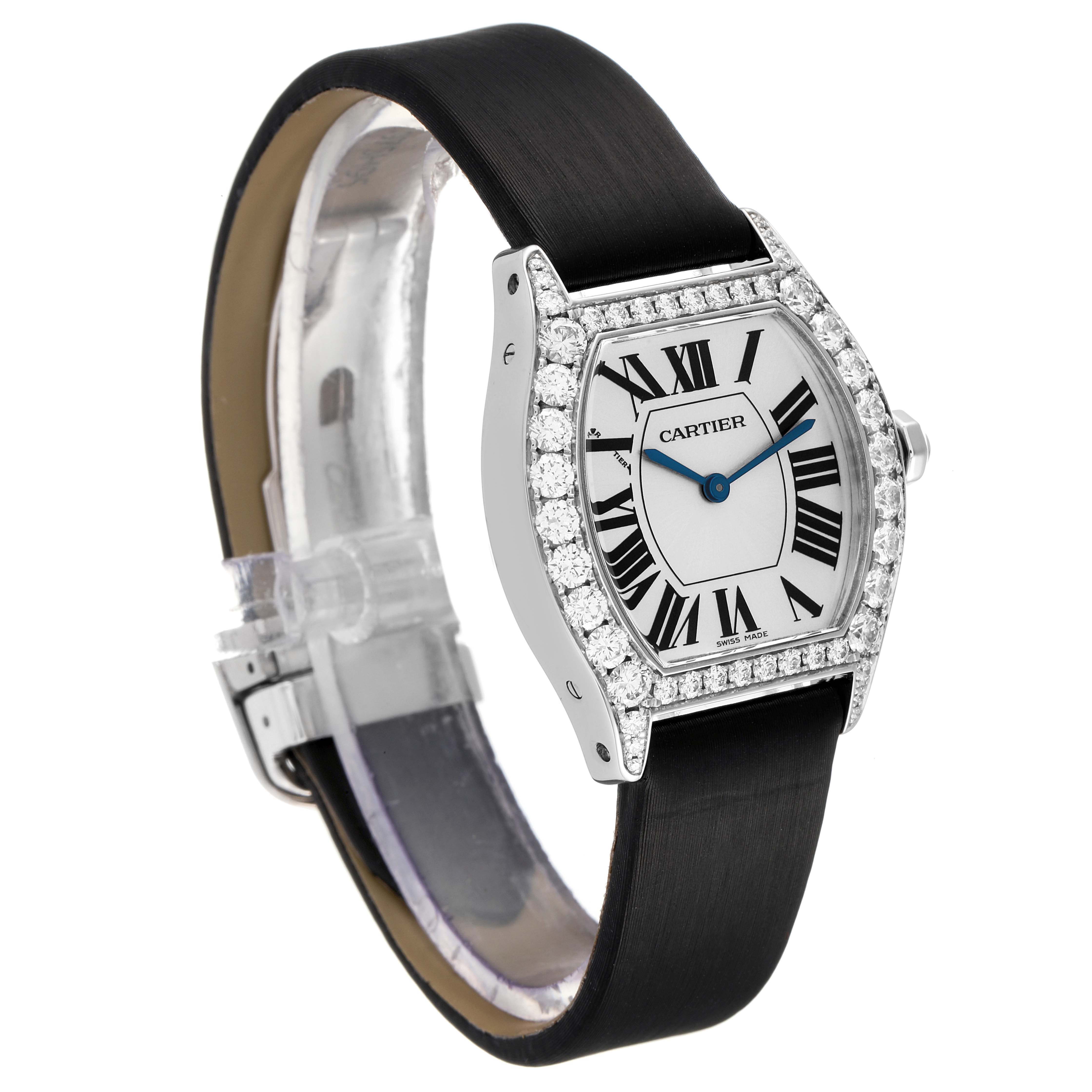 The Cartier Tortue WA507231 Women's White Gold Silver Dial WA507231 Women's White Gold Silver Dial watch is shown at an angled view, featuring its diamond-encrusted bezel, black strap, and Roman numeral dial.