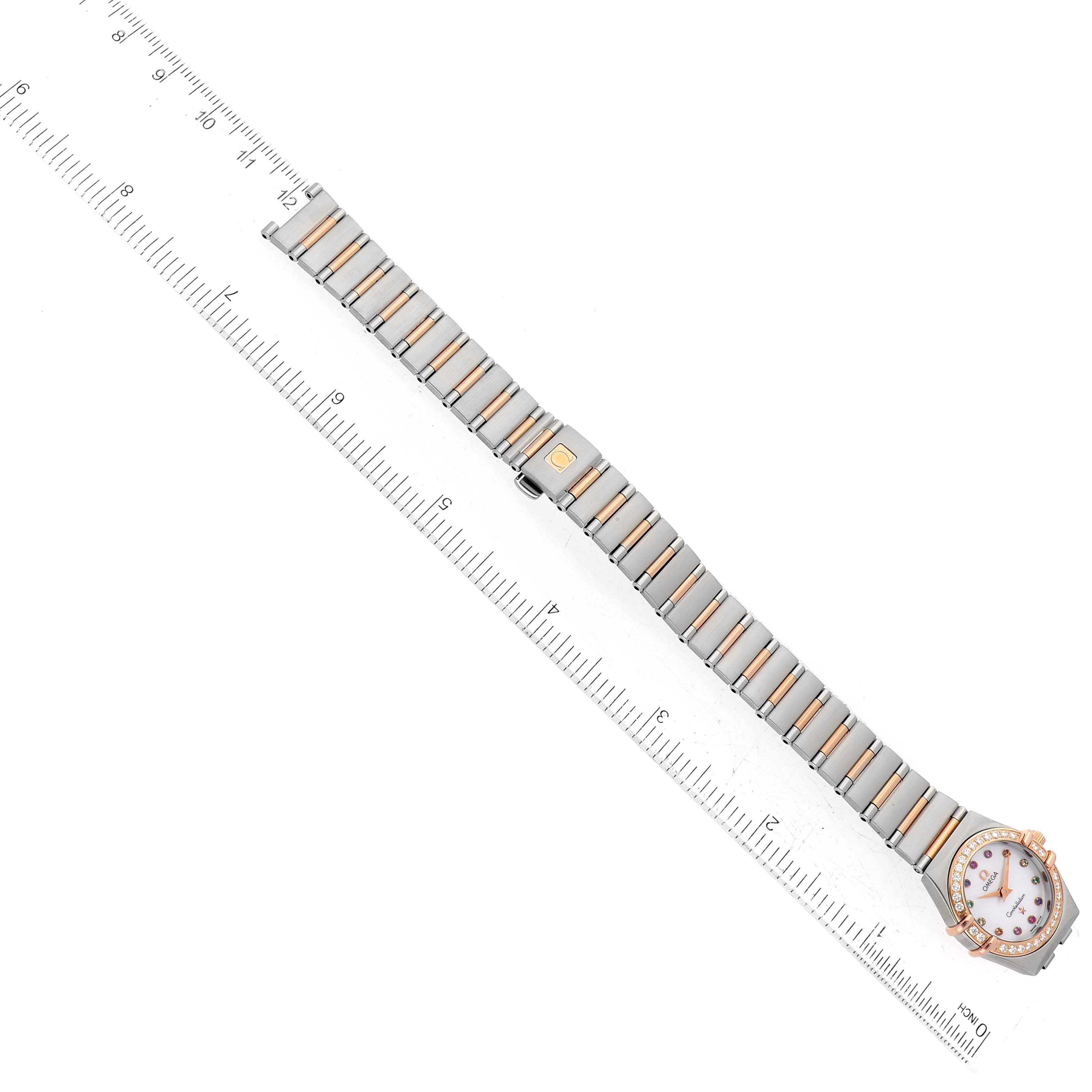 This image shows an Omega 1360.79.00 Women's Steel and Gold (two tone) Mother of Pearl Dial 1360.79.00 Women's Steel and Gold (two tone) Mother of Pearl Dial Constellation Steel Rose Gold MOP Diamond Ladies Watch 1360.79.00 laid flat with a ruler for scale.