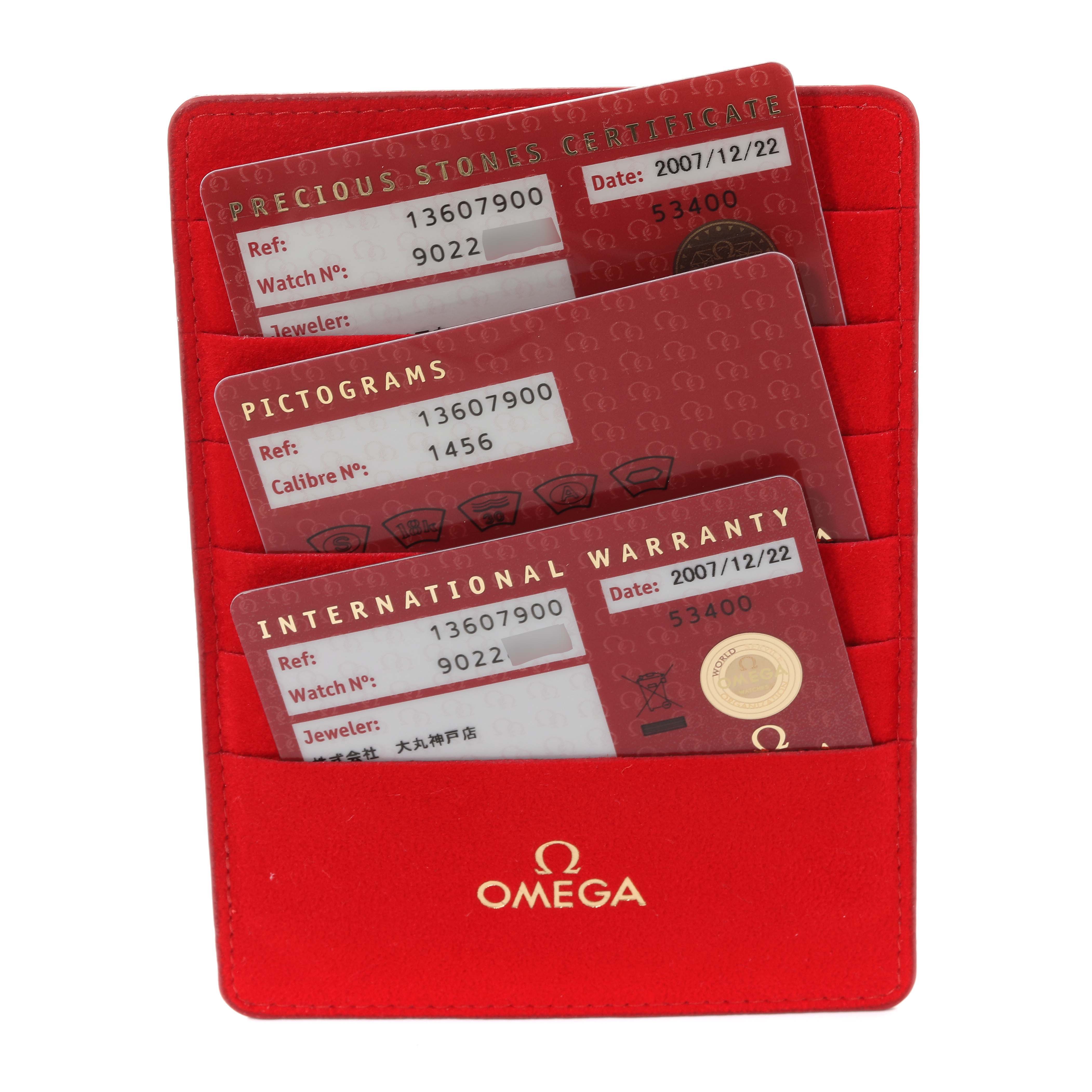 The image shows an Omega 1360.79.00 Women's Steel and Gold (two tone) Mother of Pearl Dial 1360.79.00 Women's Steel and Gold (two tone) Mother of Pearl Dial Constellation Steel Rose Gold MOP Diamond Ladies Watch 1360.79.00's warranty cards in a red Omega 1360.79.00 Women's Steel and Gold (two tone) Mother of Pearl Dial 1360.79.00 Women's Steel and Gold (two tone) Mother of Pearl Dial holder.