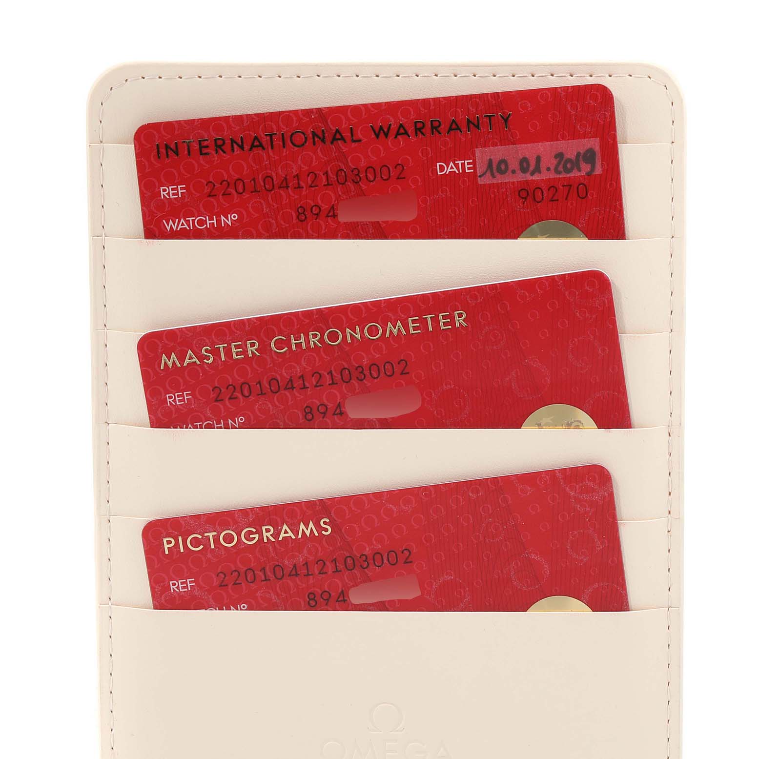 The image shows the warranty and chronometer cards for an Omega Aqua Terra 220.10.41.21.03.002 Men's Stainless Steel Blue Dial 220.10.41.21.03.002 Men's Stainless Steel Blue Dial watch placed in a holder.