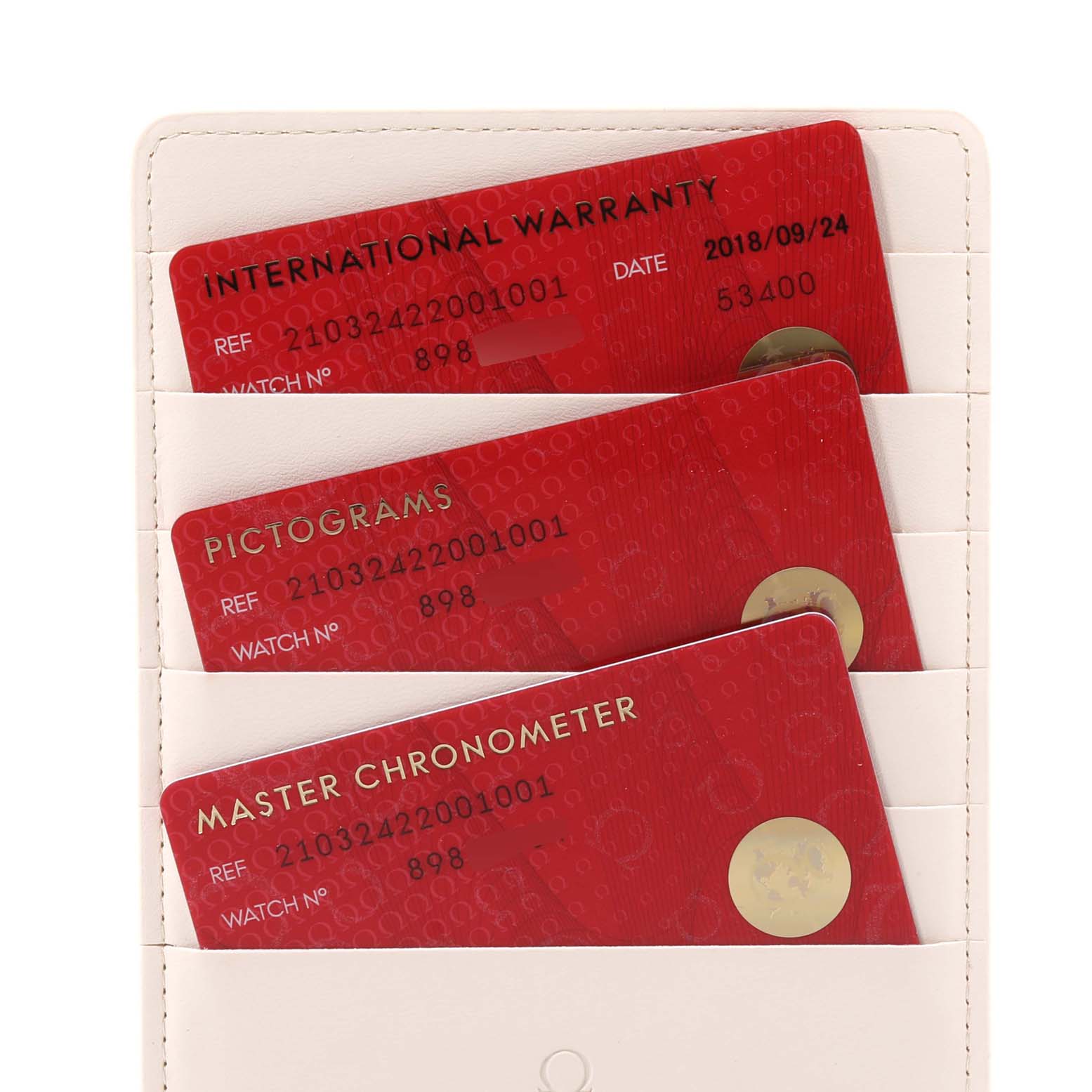 The image shows warranty and certification cards for an Omega Seamaster 210.32.42.20.01.001 Men's Stainless Steel Black Dial 210.32.42.20.01.001 Men's Stainless Steel Black Dial watch in a white cardholder.