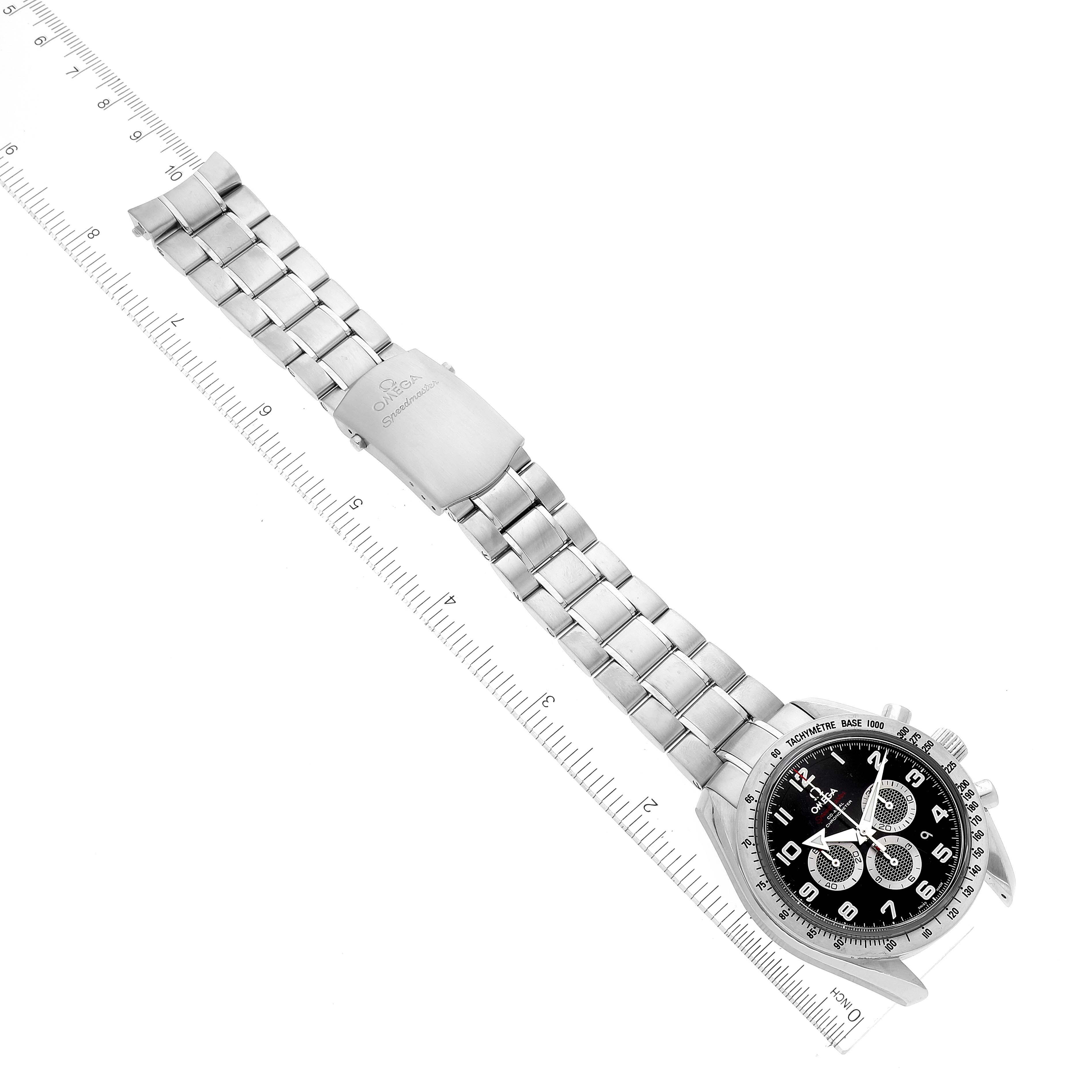 The Omega Speedmaster 321.10.44.50.01.001 Men's Stainless Steel Black Dial 321.10.44.50.01.001 Men's Stainless Steel Black Dial watch is shown at an angle, displaying the full stainless steel bracelet and clasp against a ruler for scale.