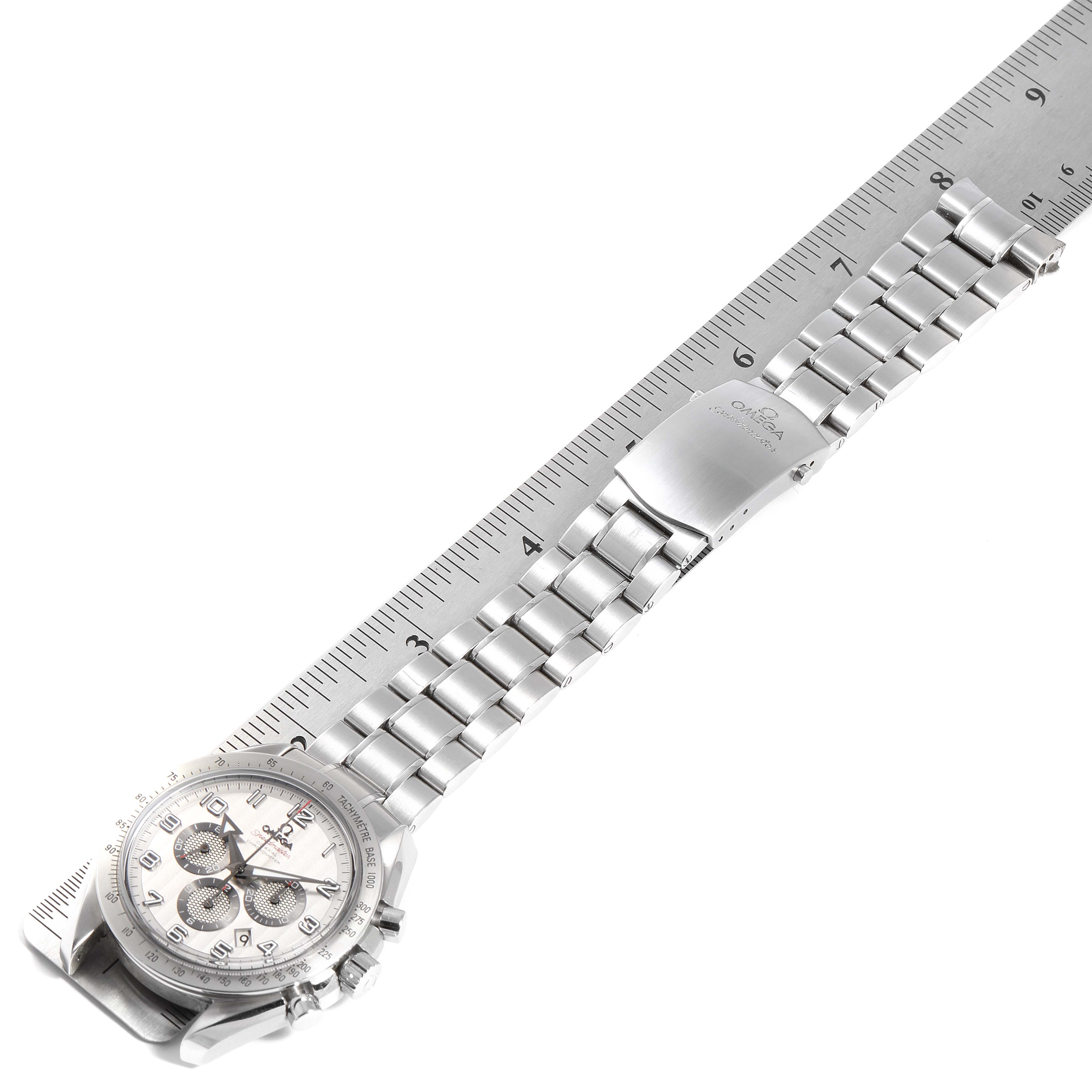 The Omega Speedmaster 321.10.44.50.02.001 Men's Stainless Steel Silver Dial 321.10.44.50.02.001 Men's Stainless Steel Silver Dial watch is viewed from above, showing the stainless steel bracelet and clasp, resting on a ruler for scale.