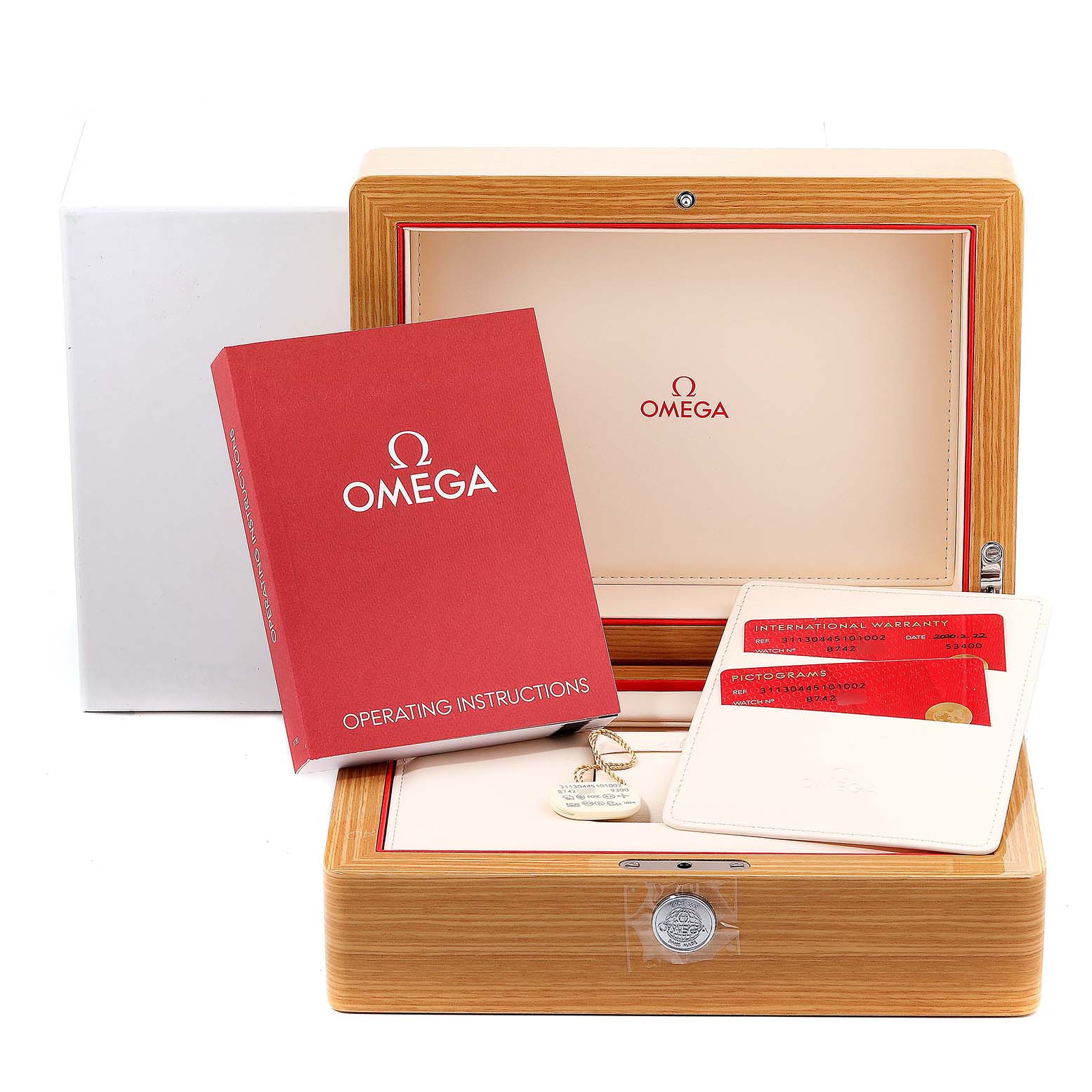 The image shows the packaging and accessories for an Omega Speedmaster 311.30.44.51.01.002 Men's Stainless Steel Black Dial 311.30.44.51.01.002 Men's Stainless Steel Black Dial, including a wooden box, operating instructions, warranty cards, and a keychain.