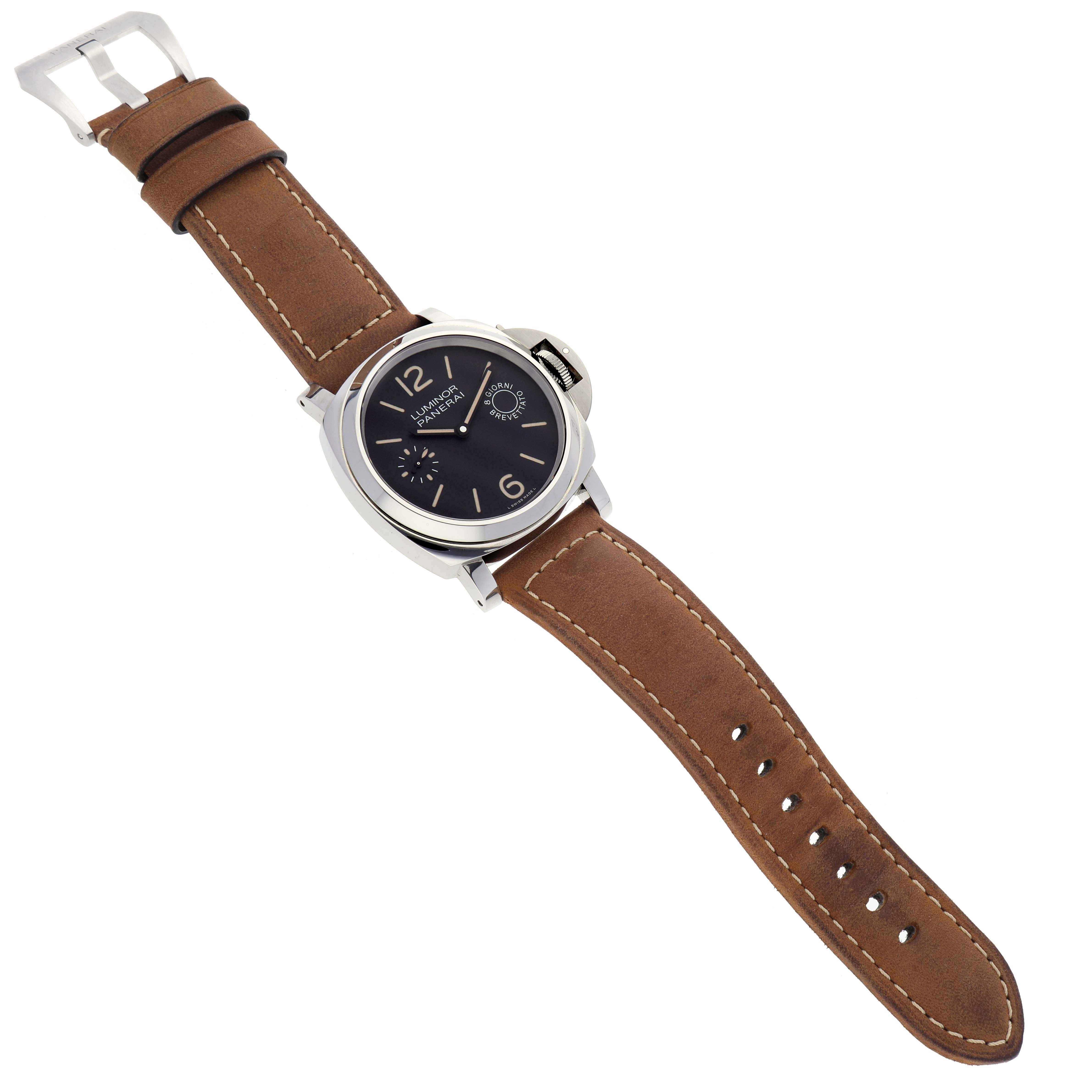 The Panerai Luminor PAM00590 Men's Stainless Steel Black Dial PAM00590 Men's Stainless Steel Black Dial watch is shown from an aerial angle, featuring a brown leather strap and a black dial.