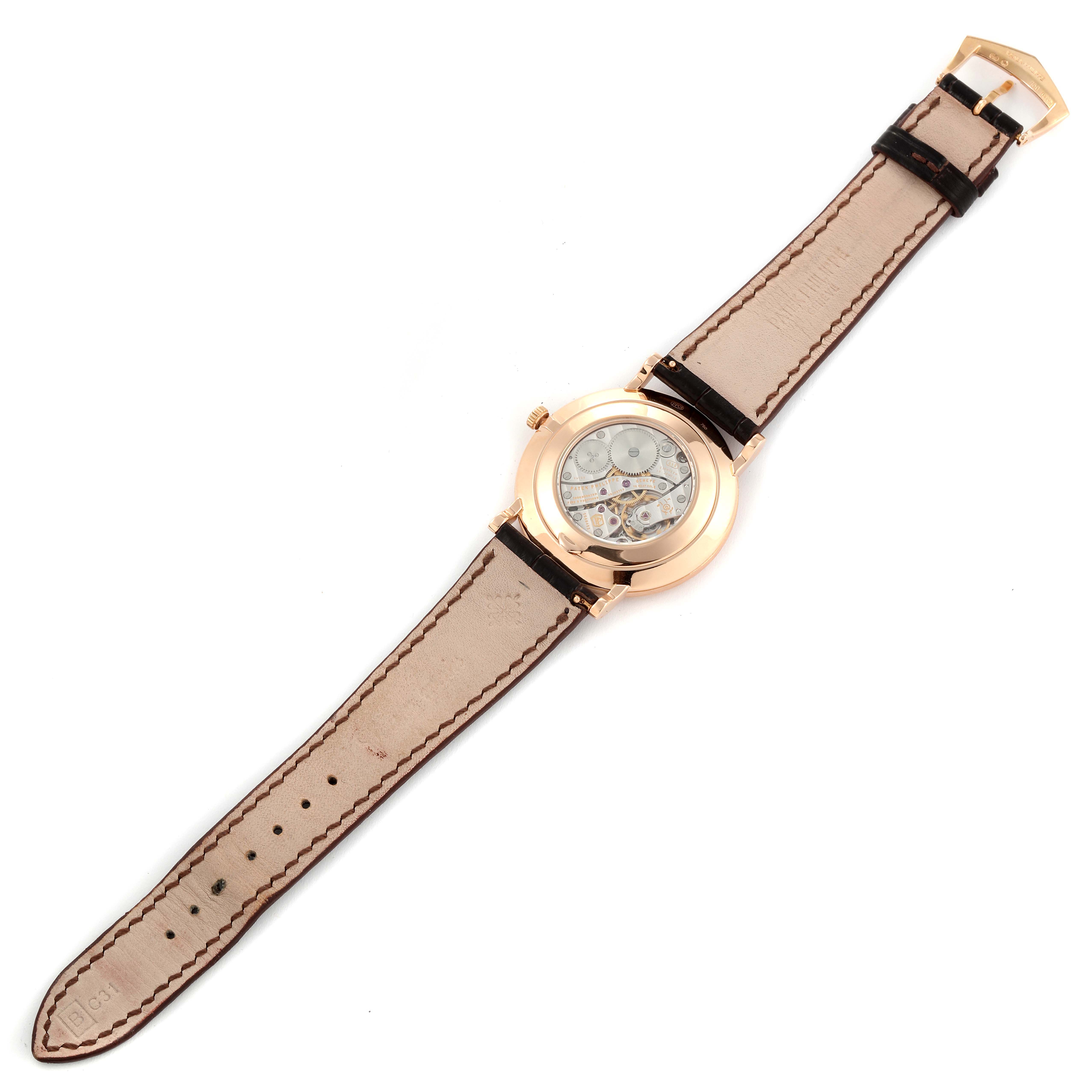 The image shows the back view of a Patek Philippe Calatrava 5119R Men's Rose Gold White Dial 5119R Men's Rose Gold White Dial watch and its leather strap.