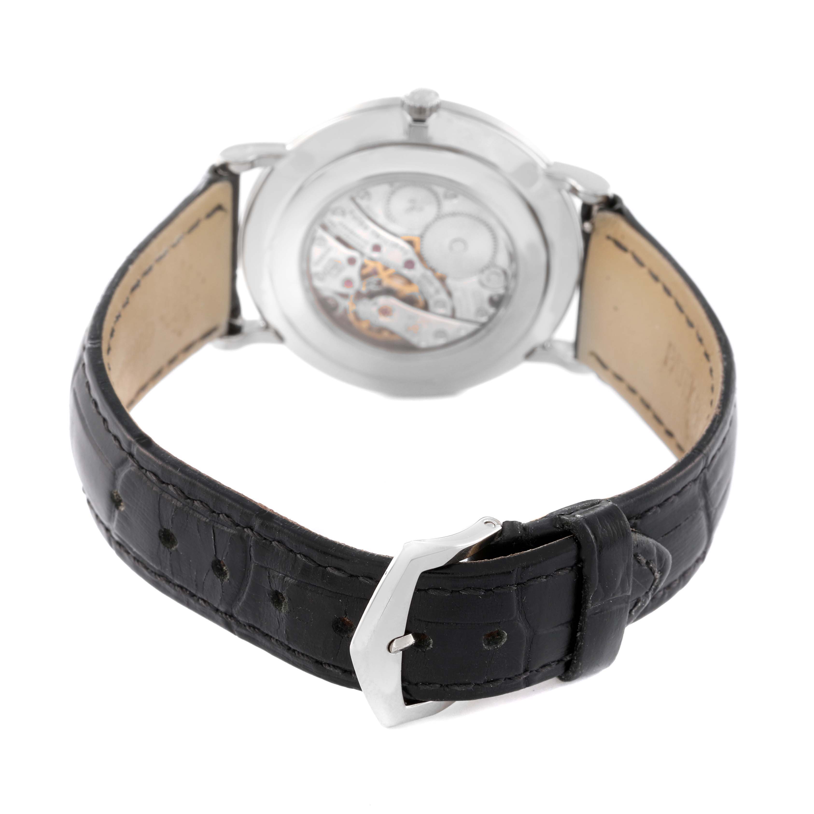 The image shows the back view of a Patek Philippe Calatrava 5119G-001 Men's White Gold White Dial 5119G-001 Men's White Gold White Dial watch, highlighting the movement through the transparent case back and the leather strap with a buckle.