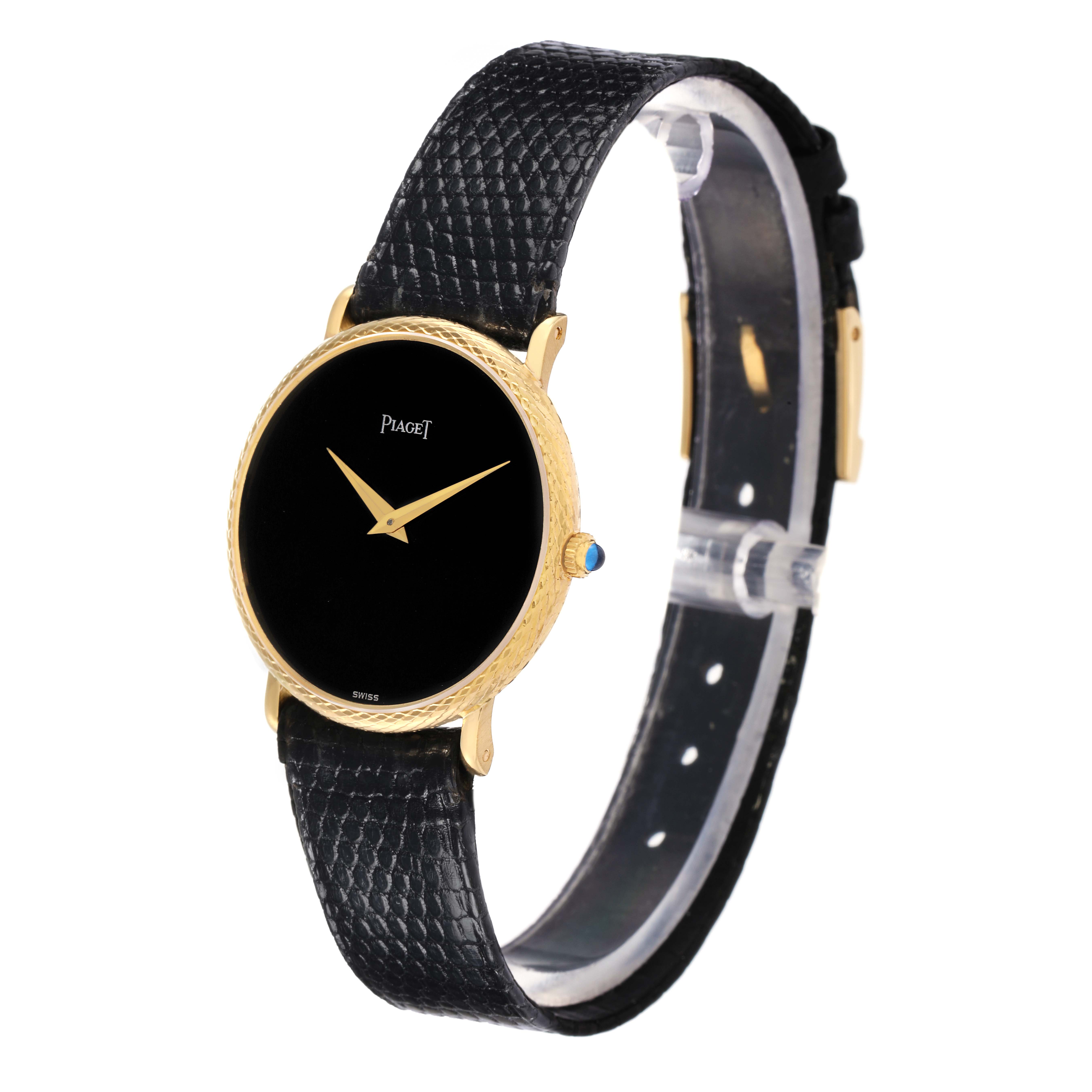 The Piaget 9026 Women's Yellow Gold Black Dial Dancer Vintage watch is shown at a slight angle, featuring its black dial, gold case, and black leather strap.