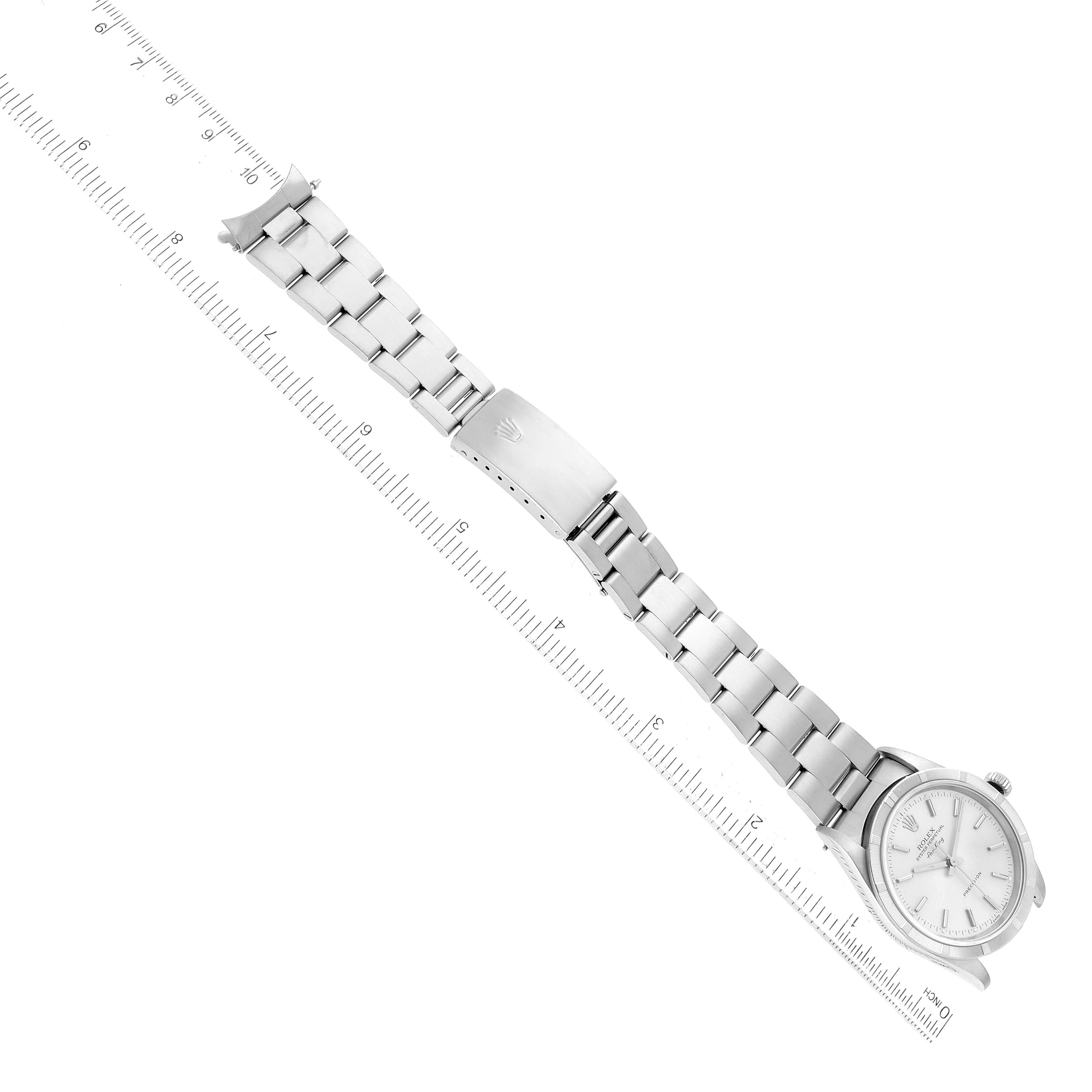 The image shows a Rolex Air-King 14010 Men's Stainless Steel Silver Dial 14010 Men's Stainless Steel Silver Dial watch lying flat with its entire bracelet and clasp visible, alongside a ruler for scale.