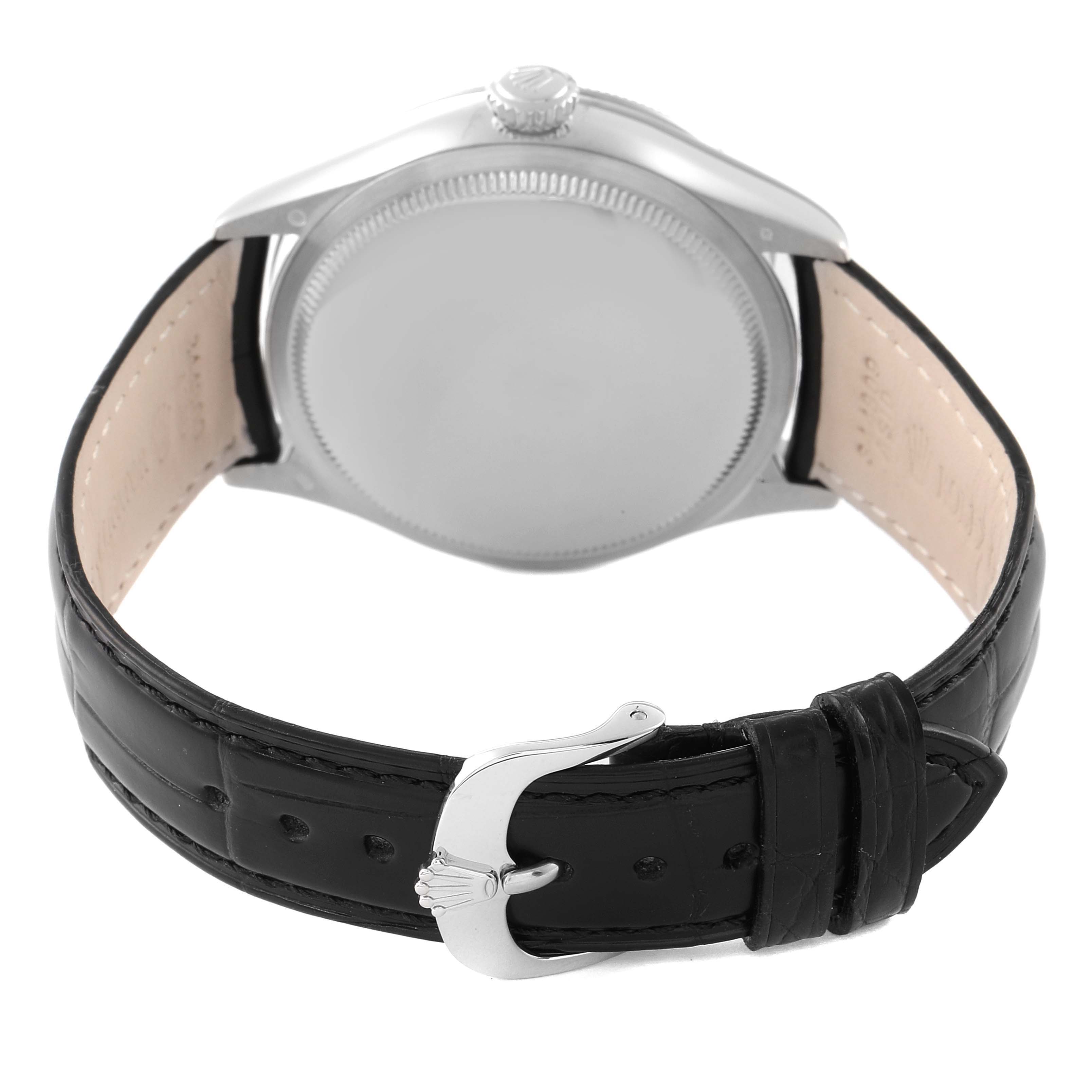The image shows the back view of a Rolex Cellini 50519 Men
s White Gold Silver Dial 50519 Men
s White Gold Silver Dial watch, highlighting its caseback, crown, and black leather strap with a buckle.