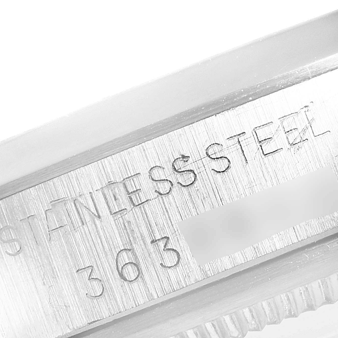 This close-up image shows the stainless steel part of the Rolex Vintage Collection 1500 Men's Stainless Steel Silver Dial 1500 Men's Stainless Steel Silver Dial watch case, engraved with text.
