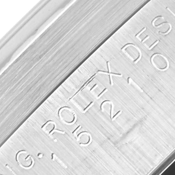 The image shows an extreme close-up of the side engraving of a Rolex Date 15210 Men
s Stainless Steel Silver Dial 15210 Men
s Stainless Steel Silver Dial model watch.