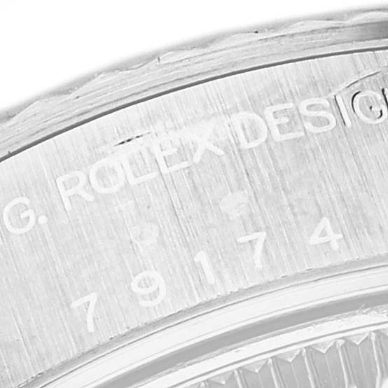 The image shows a close-up of the engraved serial and model numbers on the side of the case for the Rolex Datejust 79174 Women's Stainless Steel Black Dial 79174 Women's Stainless Steel Black Dial watch.