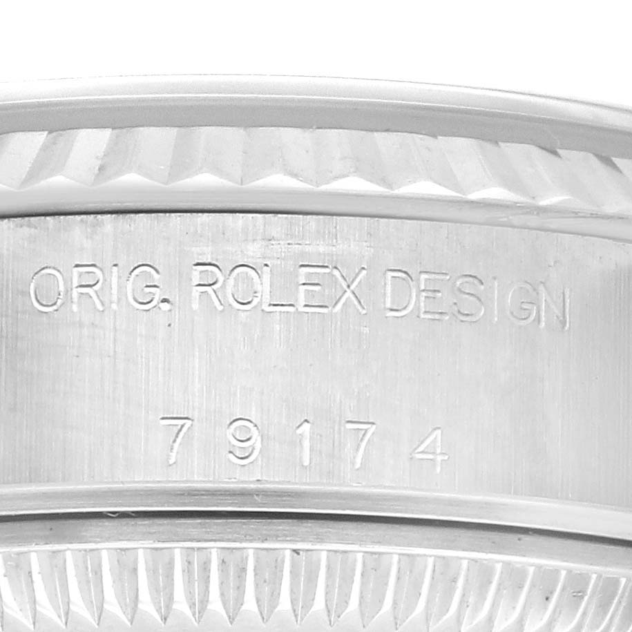 This image shows a close-up of the side engraving on the bezel of a Rolex Datejust 79174 Women's Stainless Steel Blue Dial 79174 Women's Stainless Steel Blue Dial watch, featuring the words "ORIG. ROLEX DESIGN" and the number "79174".