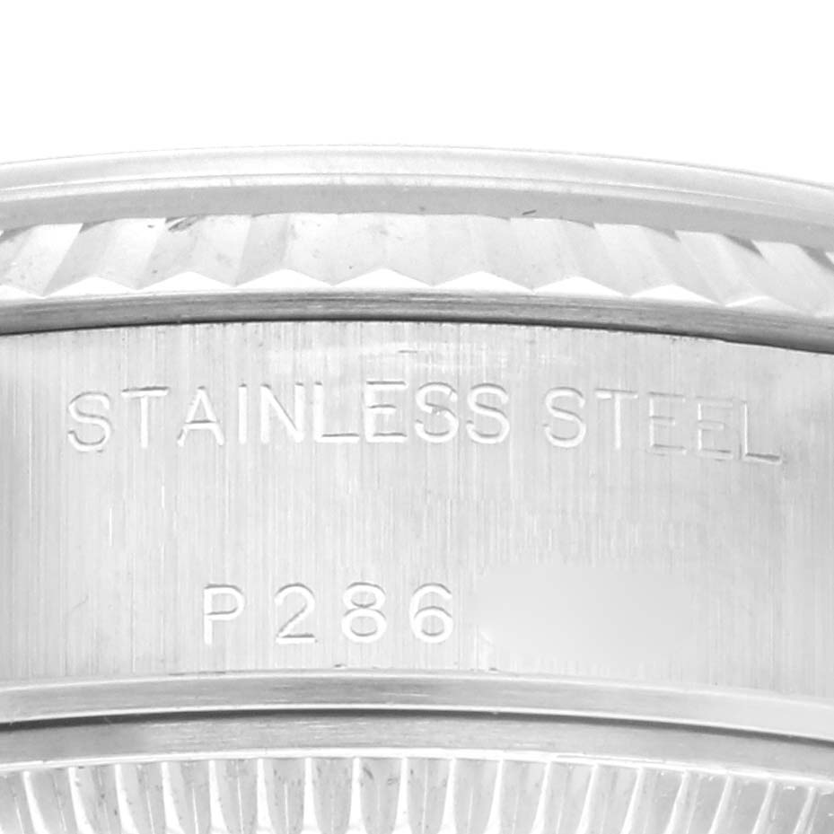Close-up of a Rolex Datejust 79174 Women's Stainless Steel Blue Dial 79174 Women's Stainless Steel Blue Dial watch band, showing the engraving "STAINLESS STEEL" and a serial number.