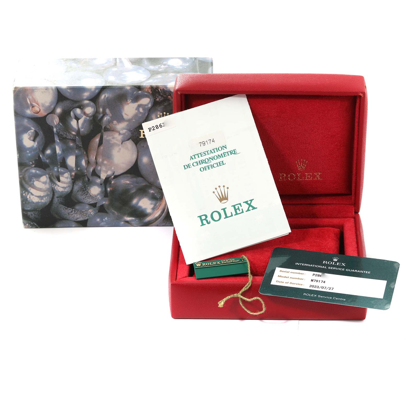 The image shows the packaging and accessories for a Rolex Datejust 79174 Women's Stainless Steel Blue Dial 79174 Women's Stainless Steel Blue Dial, including the box, manuals, and an international service guarantee card.