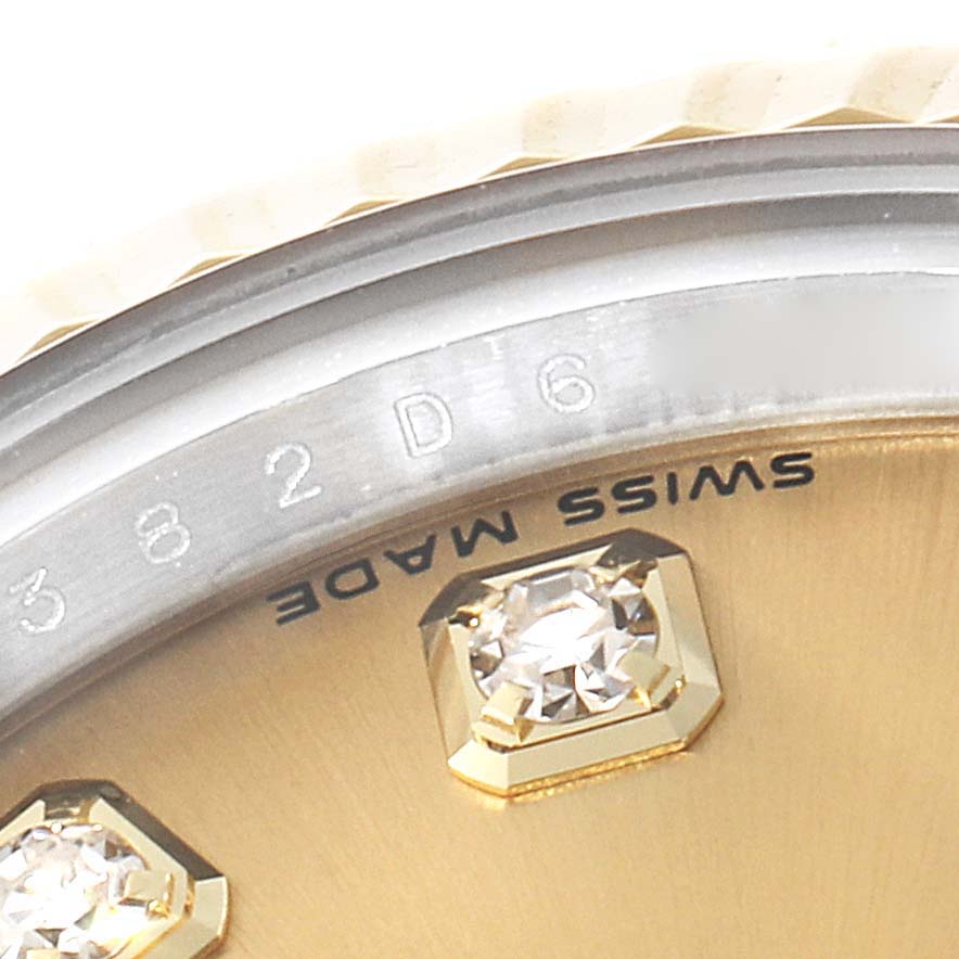The image shows a close-up of a Rolex Datejust 179173 Women's Steel and Gold (two tone) Champagne Dial 179173 Women's Steel and Gold (two tone) Champagne Dial watch dial with diamond hour markers and part of the bezel.