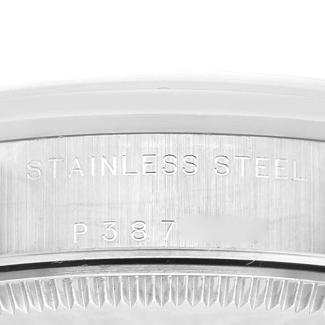 This close-up image shows the side of the stainless steel bezel on a mid-size Rolex watch.