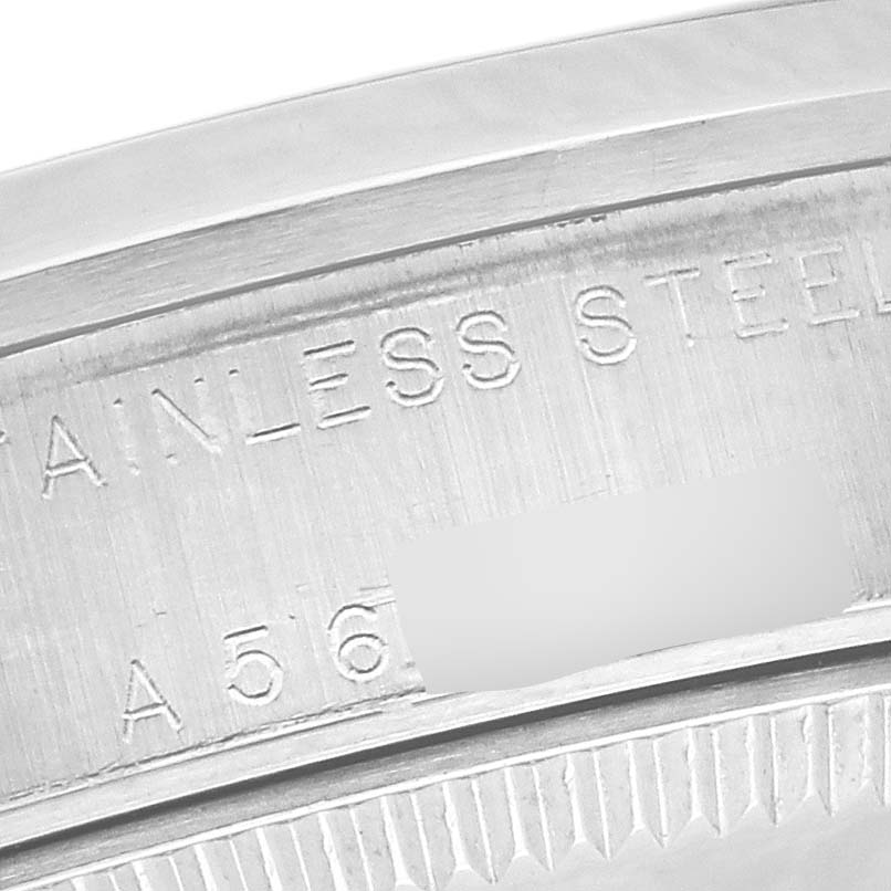This is a close-up angle of the case back engraving on a Mid-Size Rolex watch, showing the words "STAINLESS STEEL" and part of the serial number.