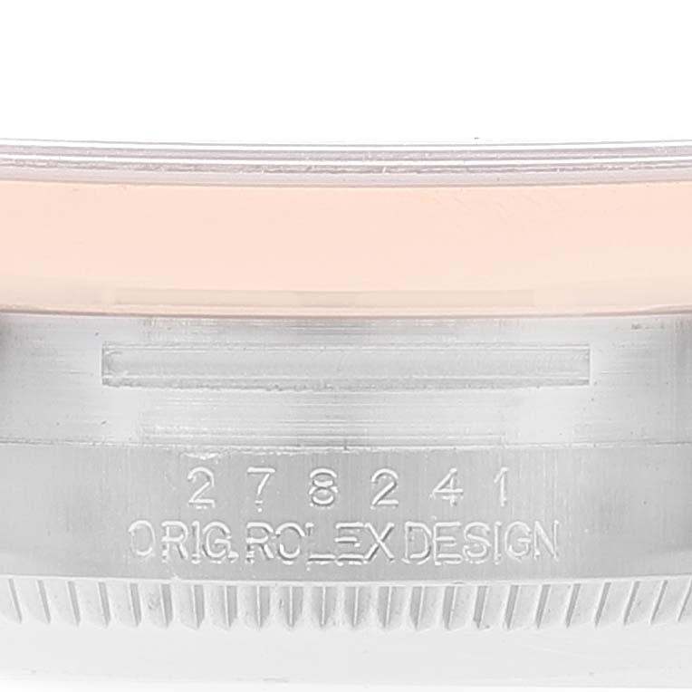 The image shows a close-up of the side of a Rolex Mid-Size 278241 Women's Steel and Gold (two tone) Silver Dial 278241 Women's Steel and Gold (two tone) Silver Dial model watch, focusing on the serial number and the "Orig. Rolex Design" engraving.