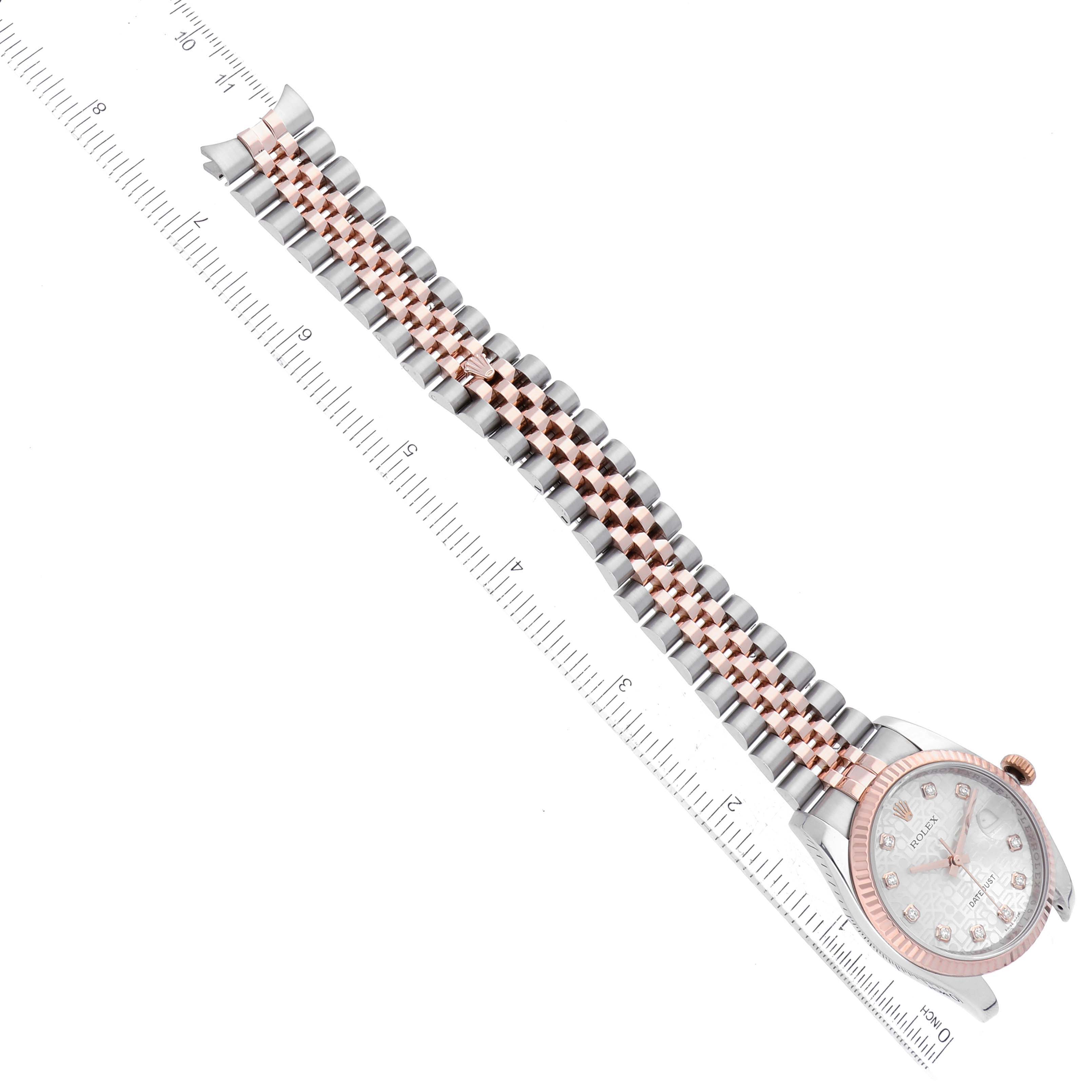 This image shows a top-down view of a Rolex Datejust 116231 Men's Steel and Gold (two tone) Silver Dial 116231 Men's Steel and Gold (two tone) Silver Dial watch, focusing on its dial, bezel, and two-tone bracelet next to a ruler.