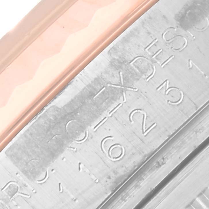 Close-up of the Rolex Datejust 116231 Men's Steel and Gold (two tone) Silver Dial 116231 Men's Steel and Gold (two tone) Silver Dial model showing part of the bezel and engraved markers on the case.