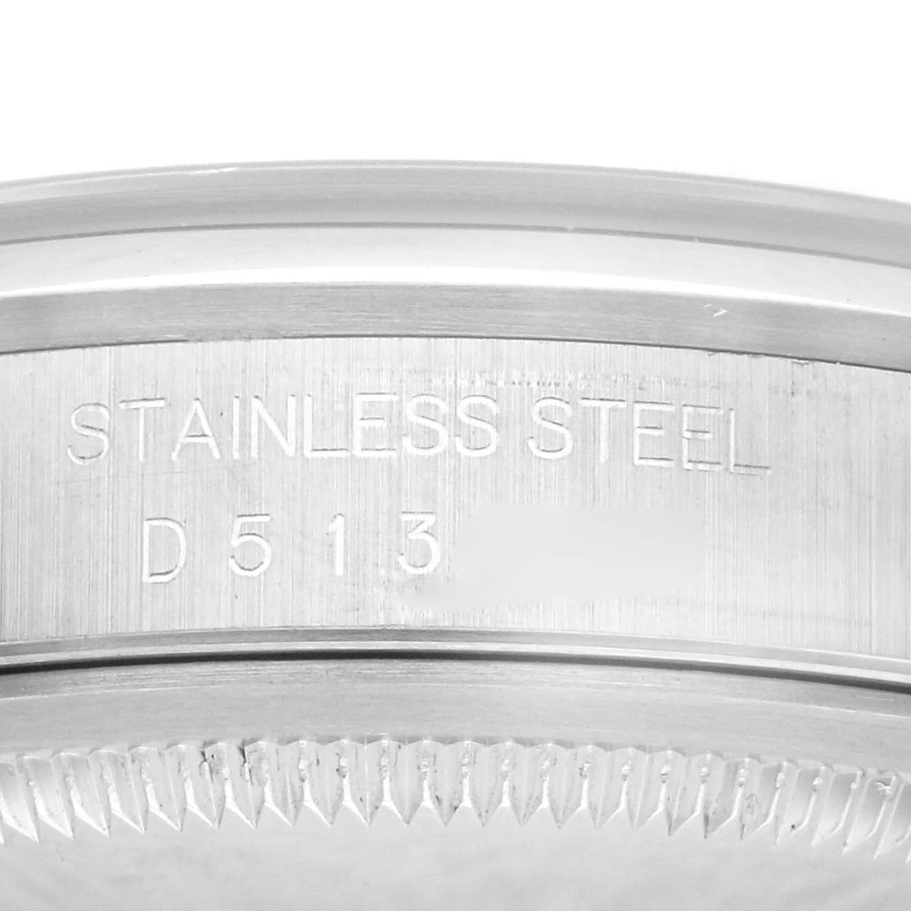 The image shows a close-up of the serial number engraving and the fluted bezel of a Rolex Datejust 16200 Men's Stainless Steel Silver Dial 16200 Men's Stainless Steel Silver Dial stainless steel watch.