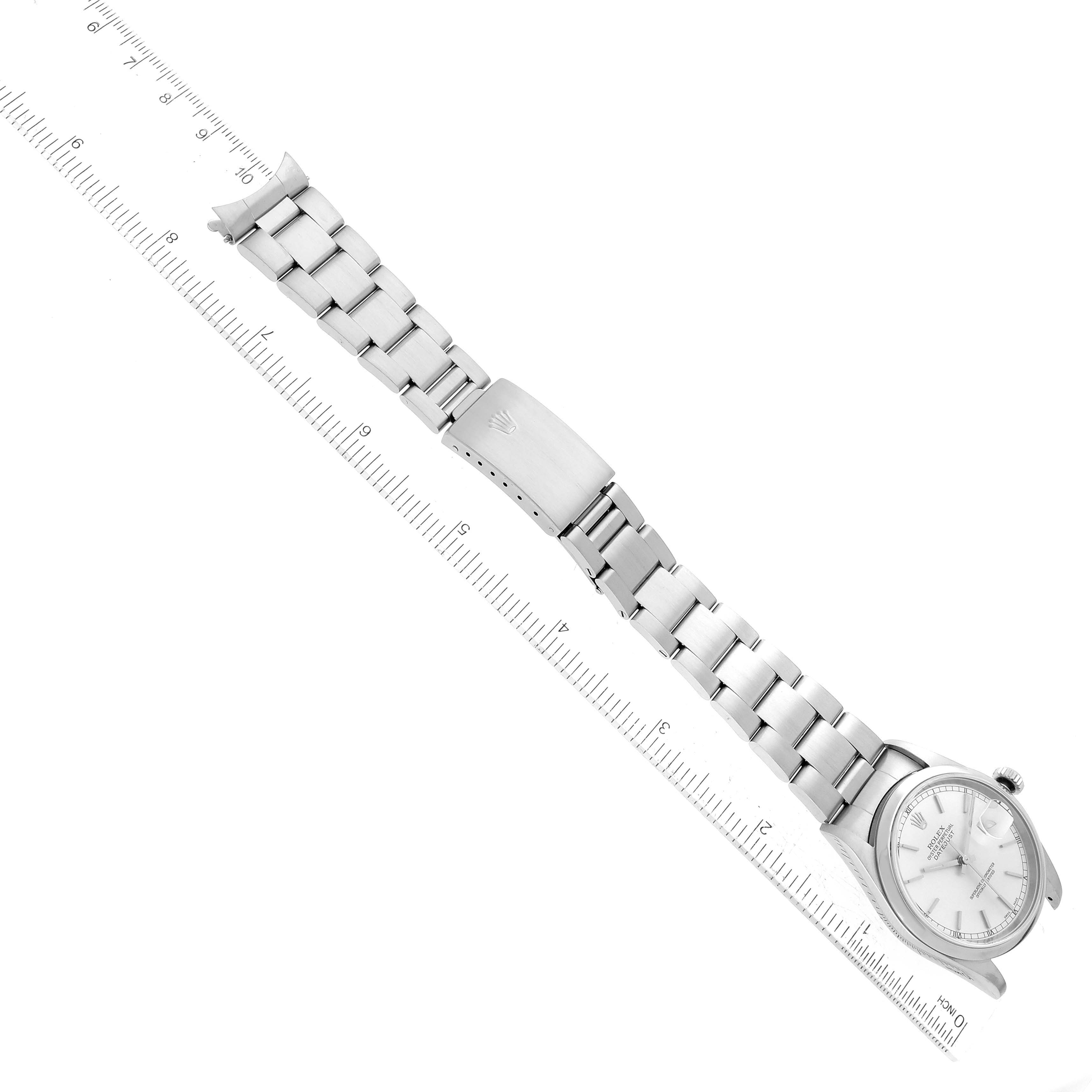 The image shows a Rolex Datejust 16200 Men's Stainless Steel Silver Dial 16200 Men's Stainless Steel Silver Dial watch laid flat, displaying the bracelet, clasp, and watch face; it's placed next to a ruler.
