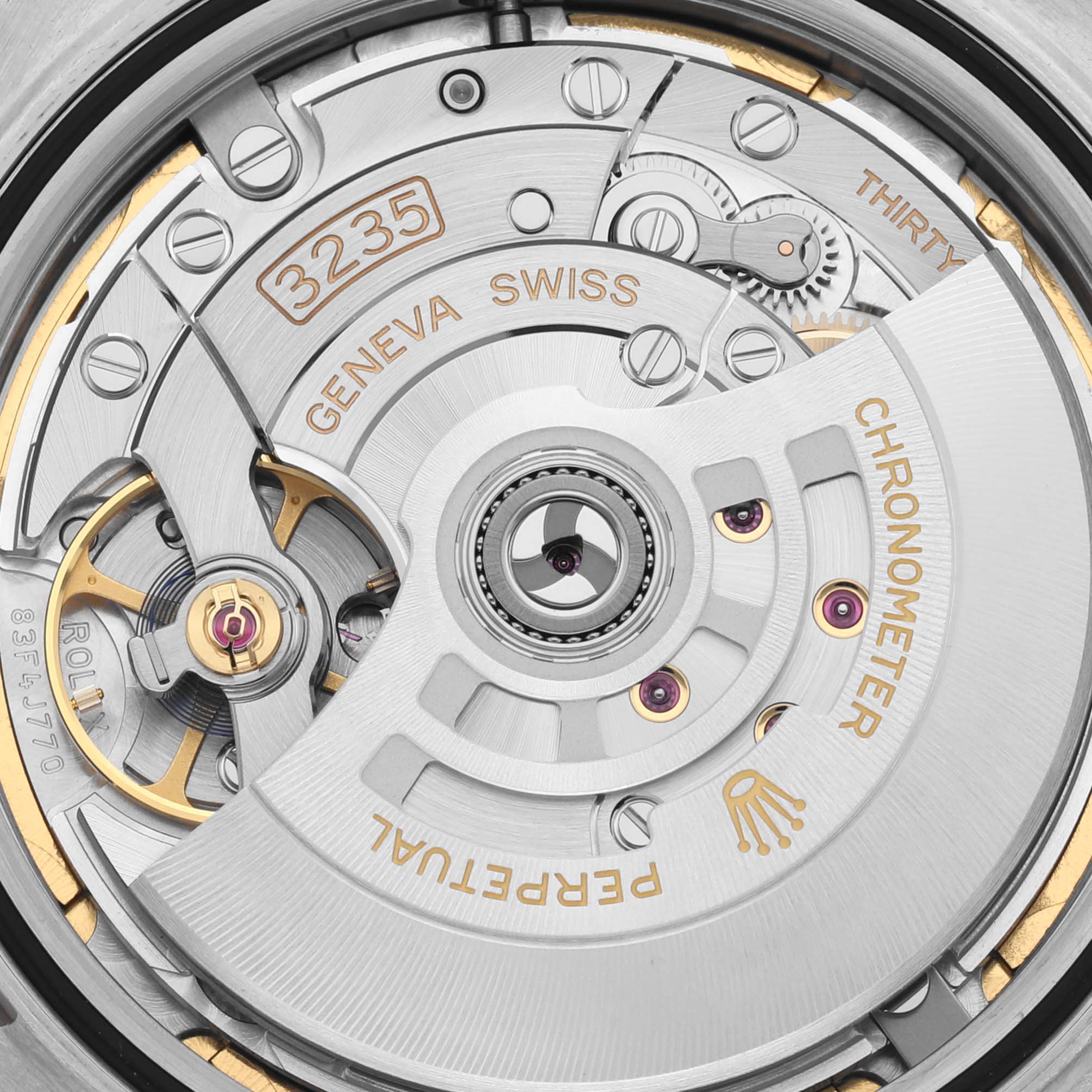 This image shows a detailed view of the movement parts of a Rolex Datejust 41 126301 Men
s Steel and Gold (two tone) Brown Dial 126301 Men
s Steel and Gold (two tone) Brown Dial model, highlighting the intricate mechanics and engraving.