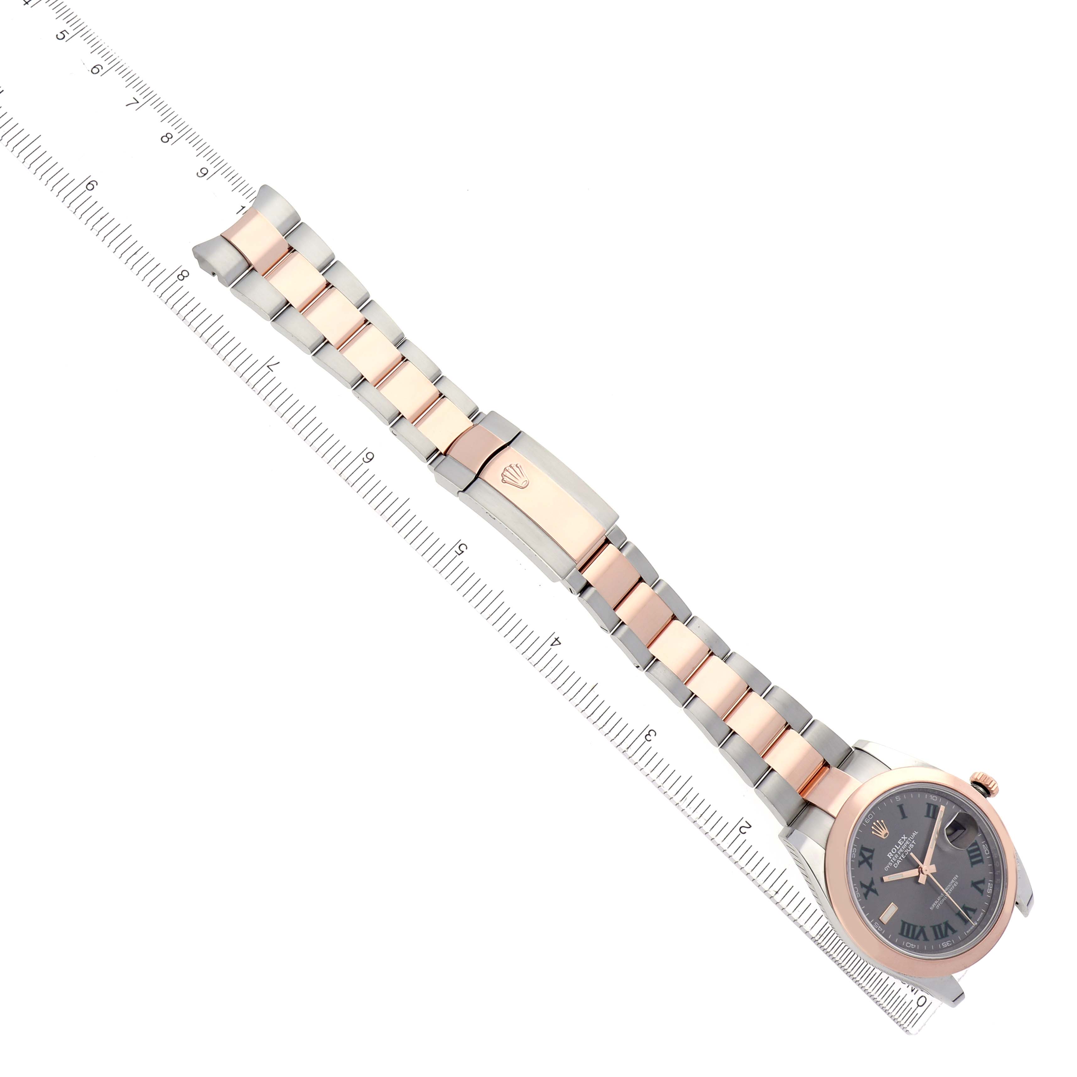 The Rolex Datejust 41 126301 Men's Steel and Gold (two tone) Grey Dial watch is shown diagonally, highlighting the face, bracelet, and clasp alongside a ruler.