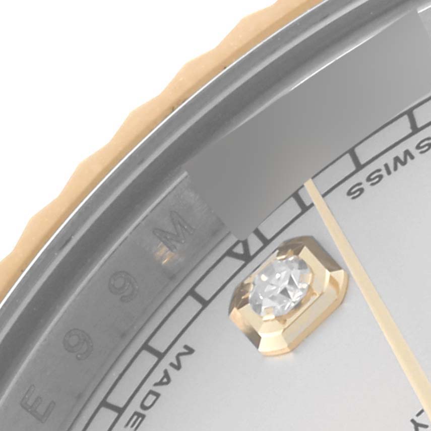 This close-up image shows the bezel, part of the dial, a diamond hour marker, and minute hand of the Rolex Datejust 41 116333 Men's Steel and Gold (two tone) Silver Dial 116333 Men's Steel and Gold (two tone) Silver Dial.