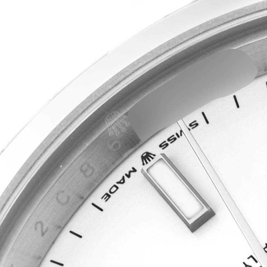 This close-up image of the Rolex Datejust 41 126300 Men's Stainless Steel White Dial 126300 Men's Stainless Steel White Dial watch shows a partial view of the dial, bezel, and the "Swiss Made" label.