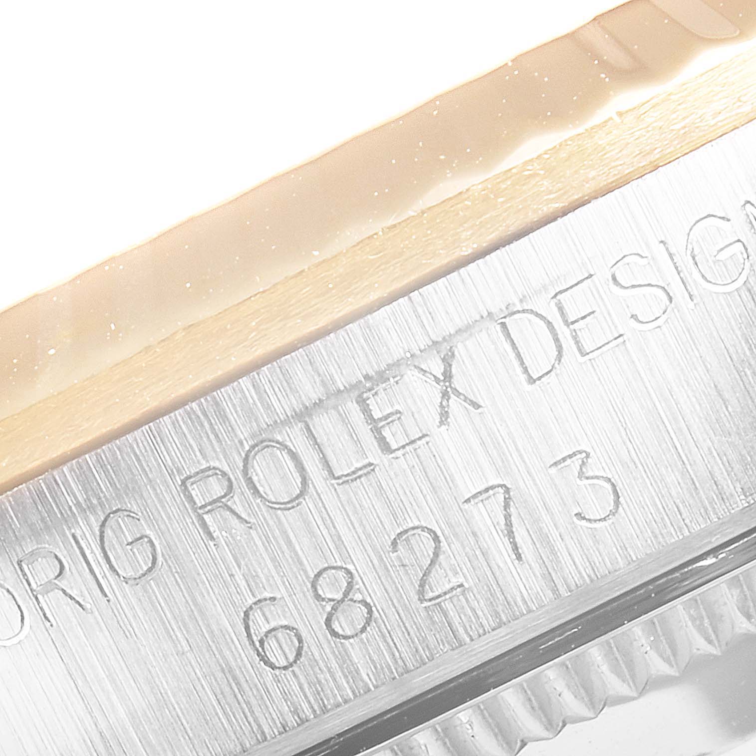 Close-up of the case side of a Mid-Size Rolex watch showing the engraved model number and "ORIG ROLEX DESIGN" text.