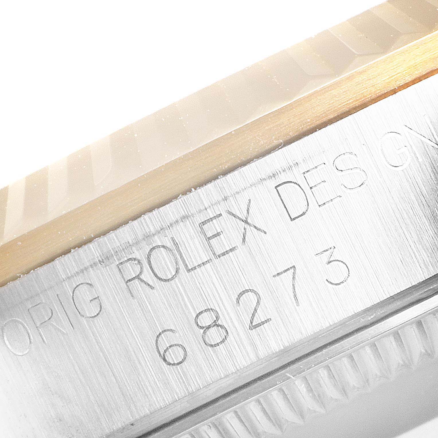 This image shows a close-up of the bezel and serial number engraving on a Mid-Size Rolex watch, model 68273.