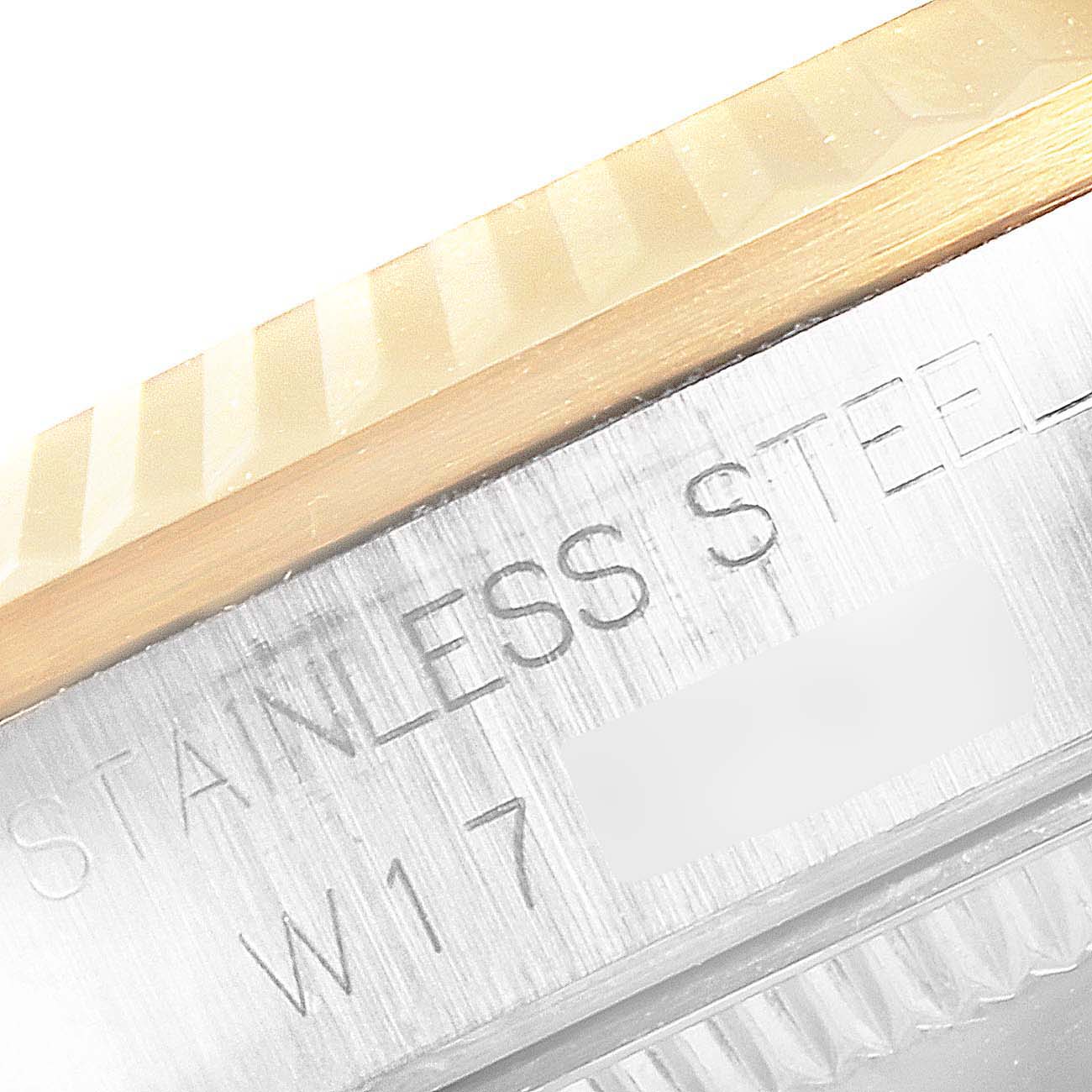 This image shows a close-up of the bezel and case edge of a Rolex Mid-Size 68273 Women
s Steel and Gold (two tone) Champagne Dial 68273 Women
s Steel and Gold (two tone) Champagne Dial model, featuring stainless steel and gold materials.