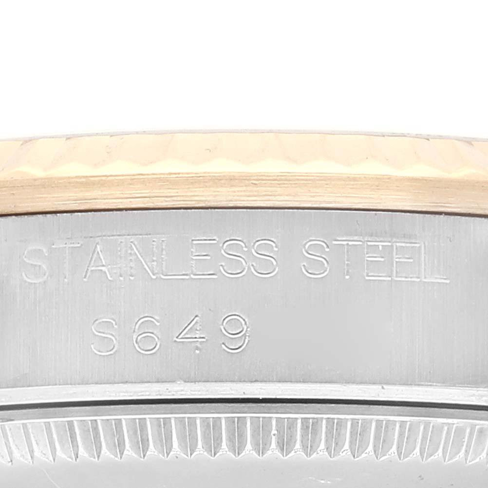 This image shows a close-up of the side case of a Rolex Mid-Size 68273 Women's Steel and Gold (two tone) White Dial 68273 Women's Steel and Gold (two tone) White Dial model watch, highlighting the "Stainless Steel" engraving and serial number.