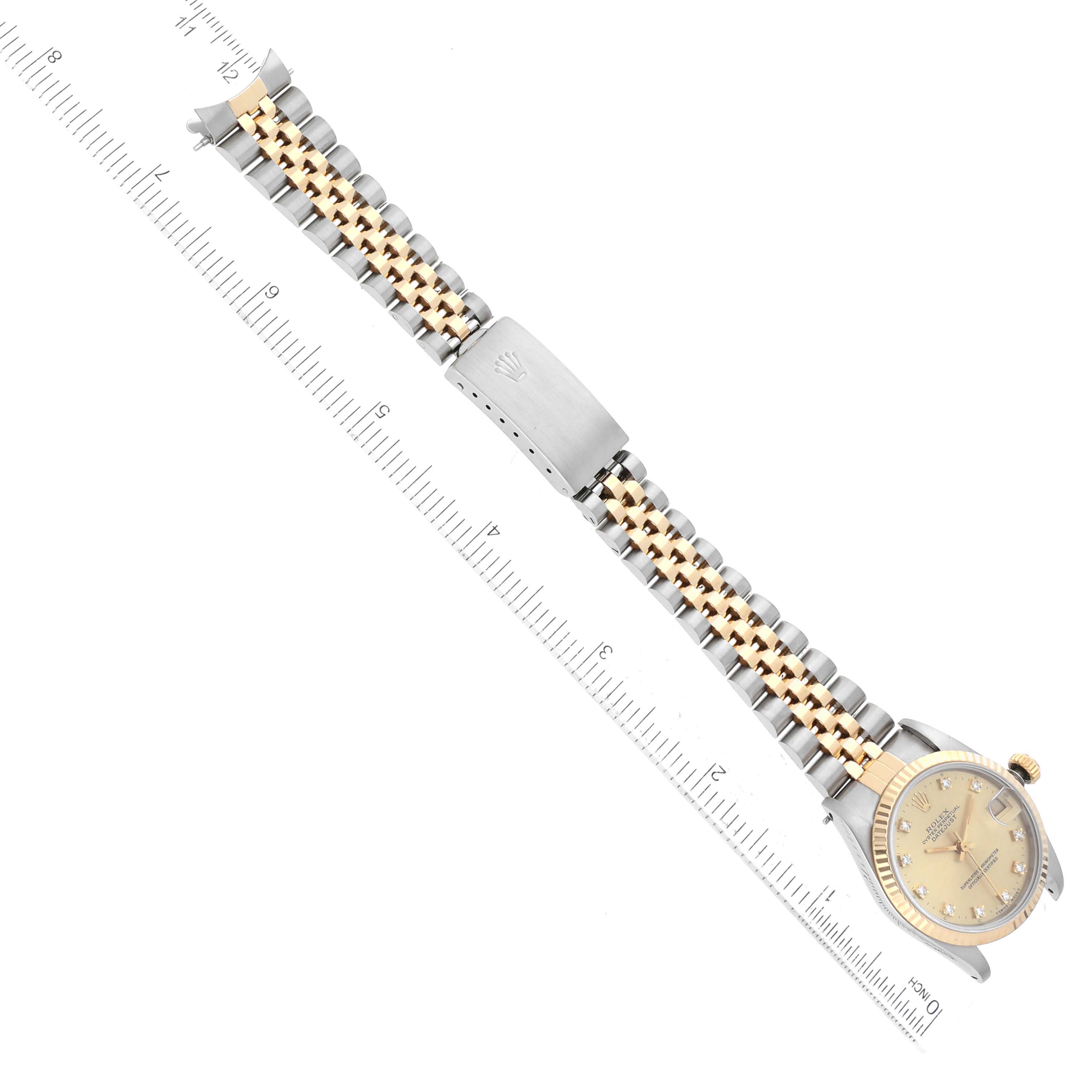 The watch is a Mid-Size Rolex, shown from a top-down angle, displaying the face, bracelet, and clasp of the timepiece.