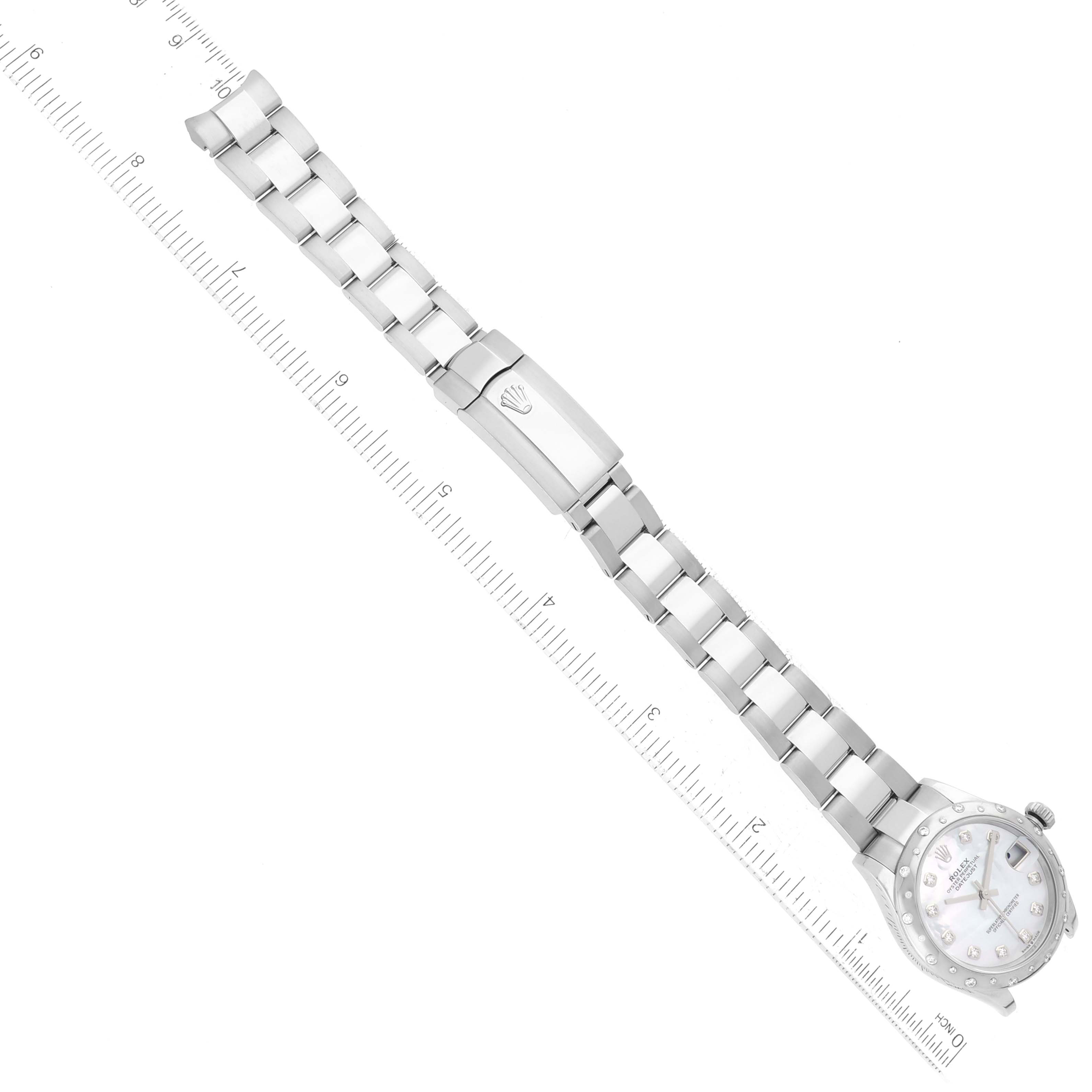This image shows a Rolex Mid-Size 278344RBR Women's White Gold Mother of Pearl Dial 278344RBR Women's White Gold Mother of Pearl Dial watch horizontally, highlighting the bracelet and clasp alongside a ruler for scale.
