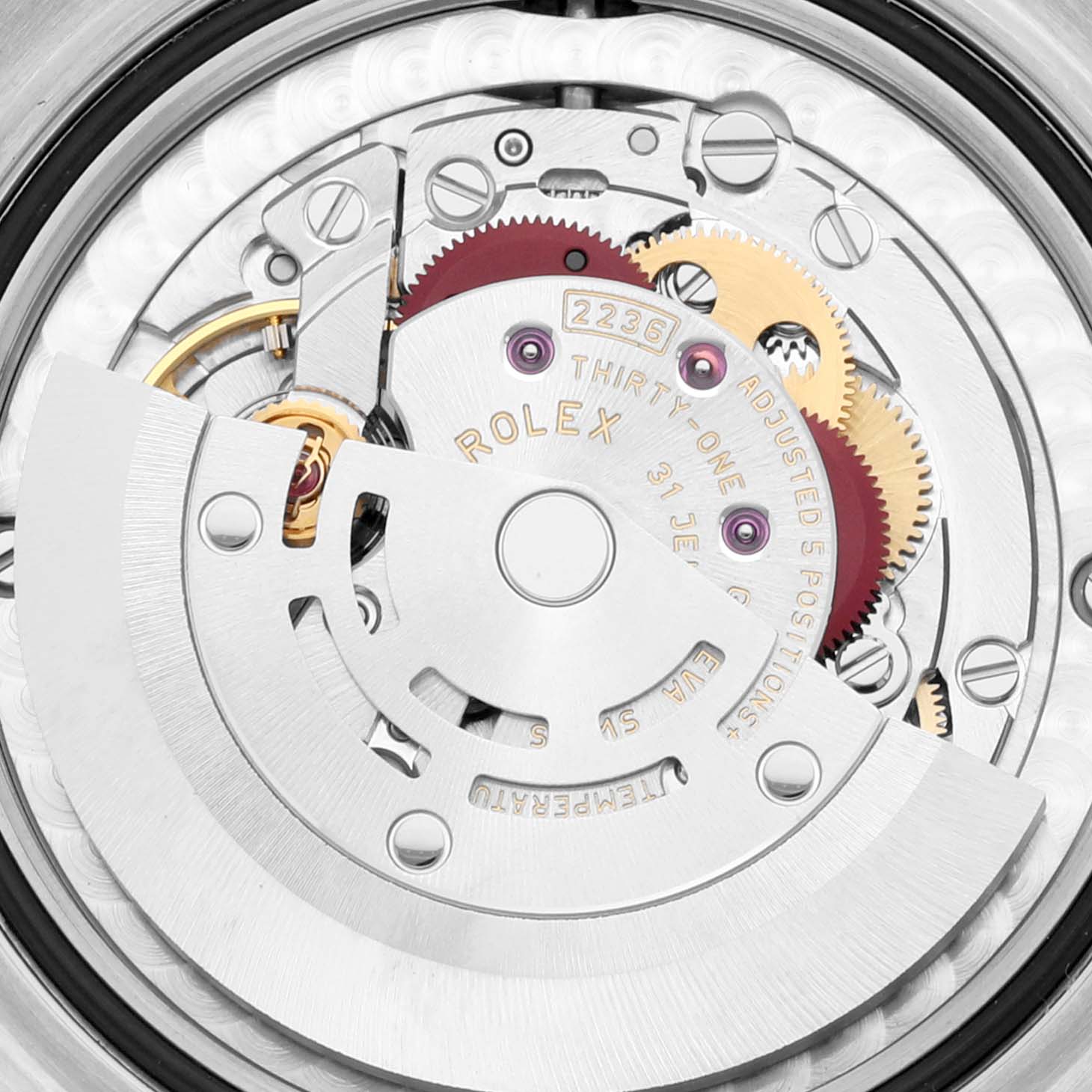 This is a close-up view of the internal movement mechanism of a Mid-Size Rolex watch, showing gears, jewels, and the rotor.