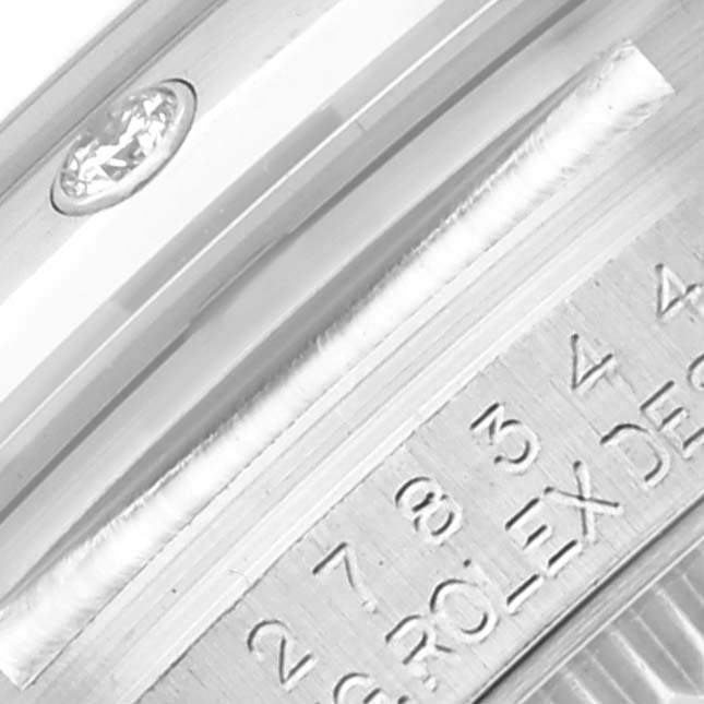The image shows a close-up of the Rolex Mid-Size 278344RBR Women's White Gold Mother of Pearl Dial 278344RBR Women's White Gold Mother of Pearl Dial watch, focusing on the serial number engraving on the case edge and part of the bezel.