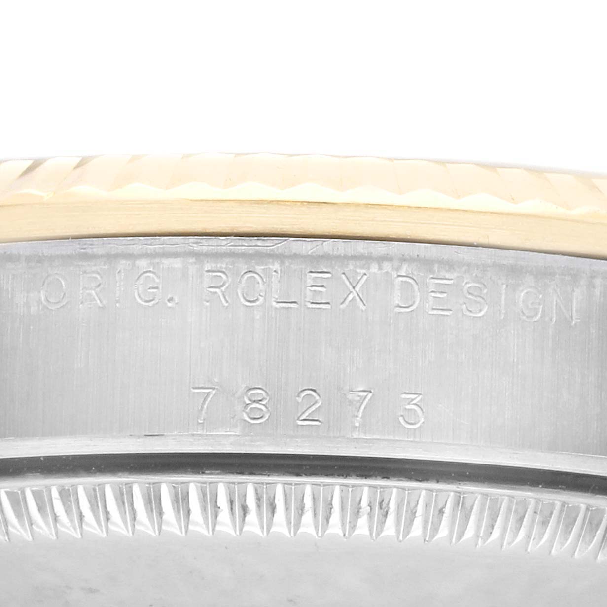 This image shows a close-up of the serial number and "ORIG. ROLEX DESIGN" engraving on a Rolex Mid-Size 78273 Women's Steel and Gold (two tone) Champagne Dial 78273 Women's Steel and Gold (two tone) Champagne Dial watch casing.