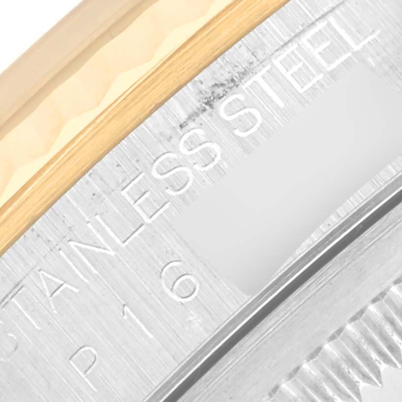 This close-up of a Rolex Datejust 16233 Men's Steel and Gold (two tone) Champagne Dial 16233 Men's Steel and Gold (two tone) Champagne Dial model showcases a partial view of the watch case's edge, highlighting the stainless steel and gold components.