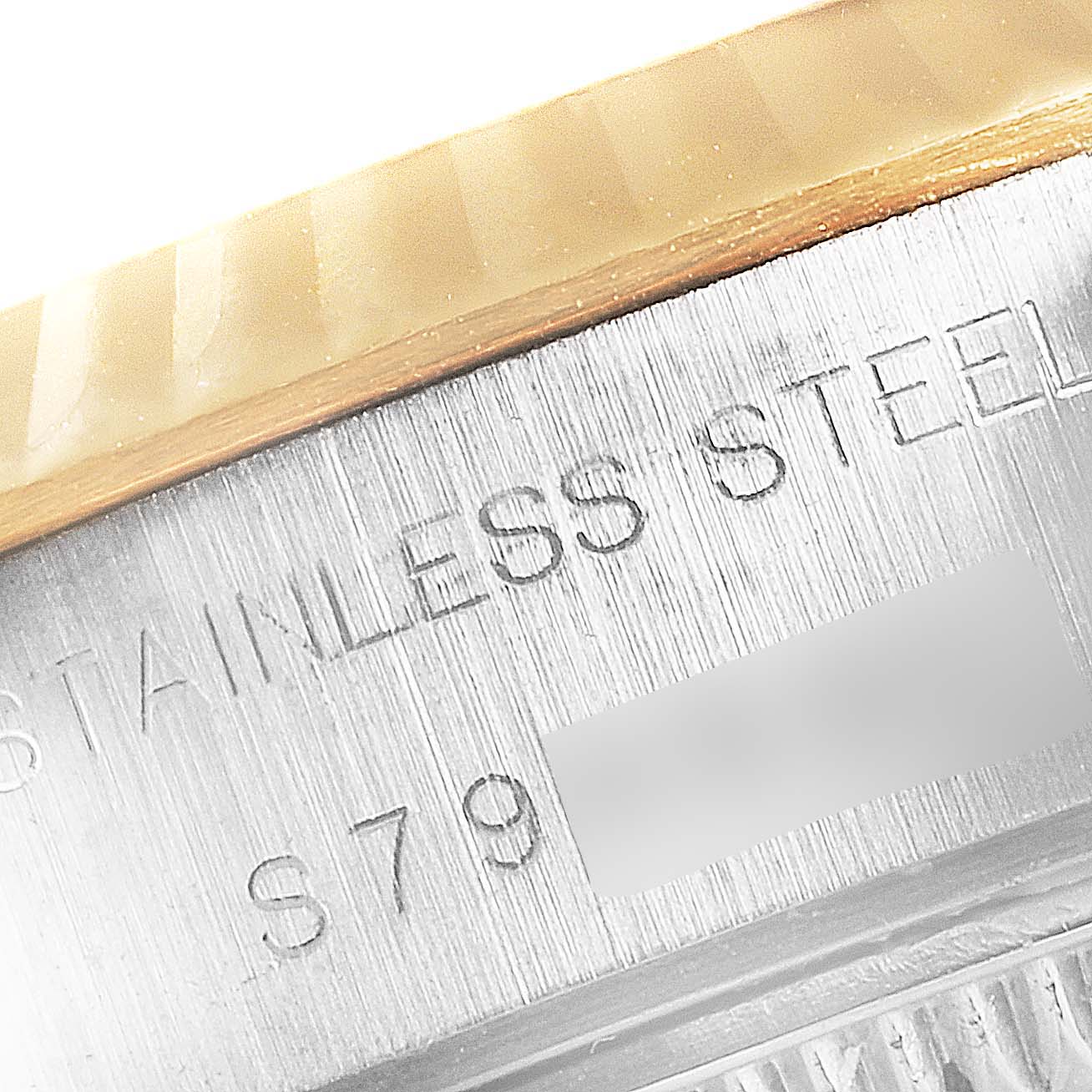 This close-up image shows the side of a Rolex Datejust 69173 Women's Steel and Gold (two tone) Blue Dial 69173 Women's Steel and Gold (two tone) Blue Dial watch case, highlighting the “STAINLESS STEEL” engraving.