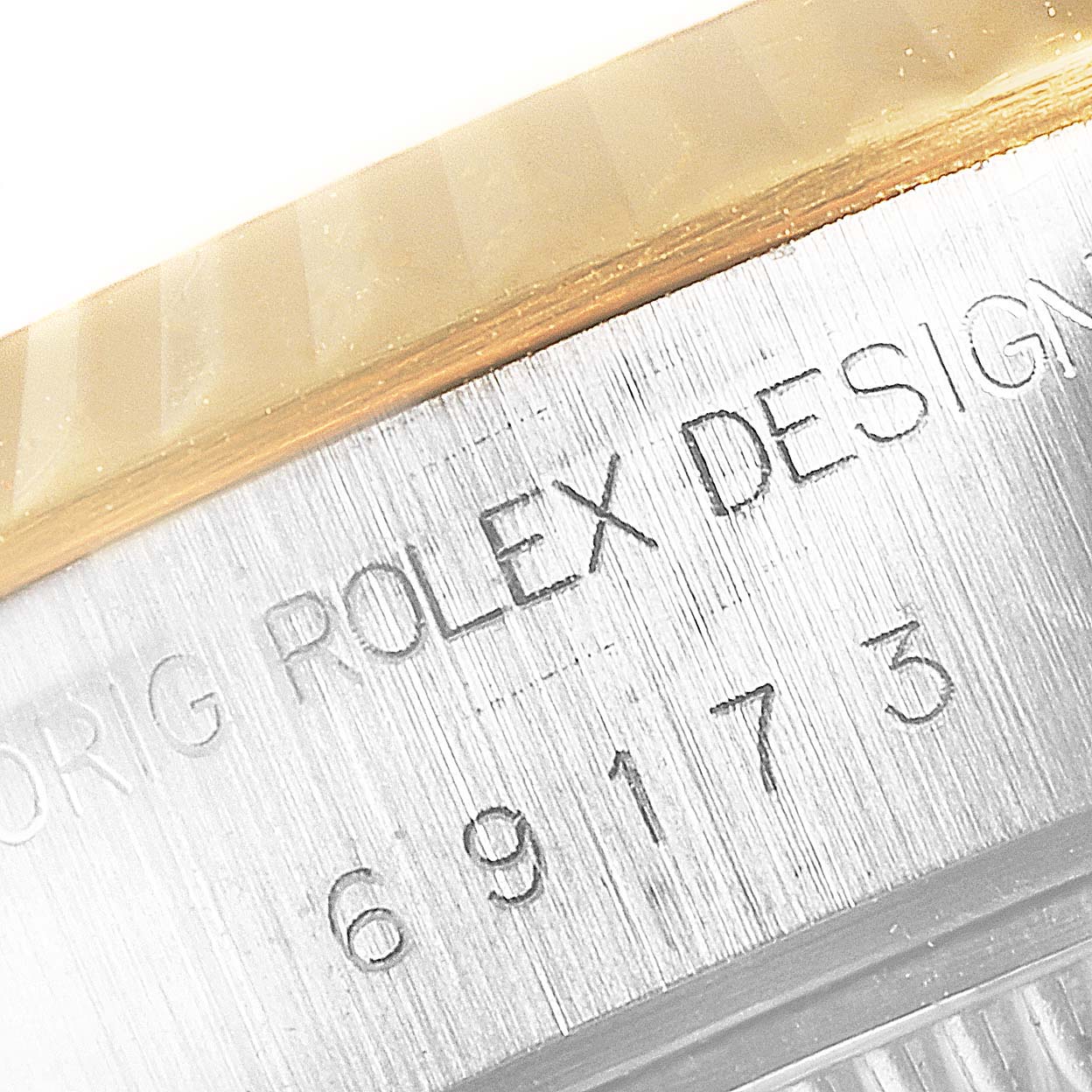 This image shows a close-up of the serial number engraving and bezel of a Rolex Datejust 69173 Women's Steel and Gold (two tone) Blue Dial 69173 Women's Steel and Gold (two tone) Blue Dial watch.
