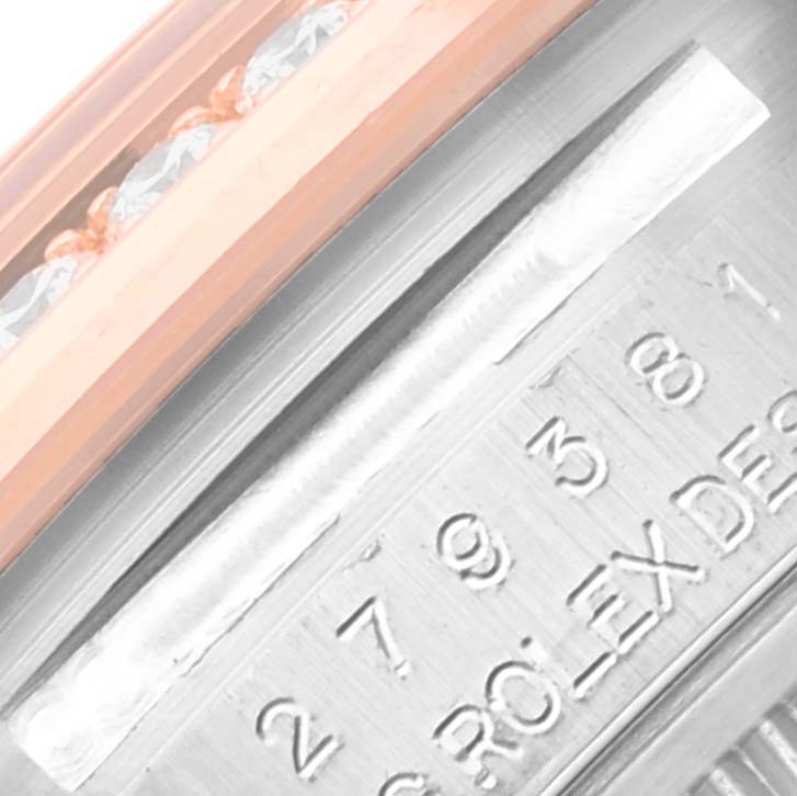 The image shows a close-up of the Rolex Datejust 279381RBR Women's Steel and Gold (two tone) Mother of Pearl Dial 279381RBR Women's Steel and Gold (two tone) Mother of Pearl Dial watch's case, focusing on the serial number and the diamond-set bezel.