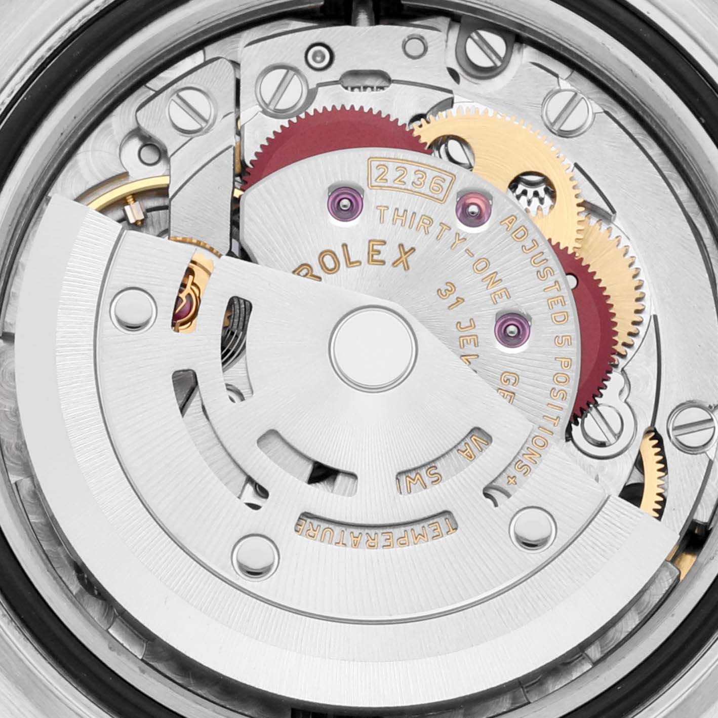 This is a close-up view of the movement inside a Rolex Datejust 279381RBR Women's Steel and Gold (two tone) Mother of Pearl Dial 279381RBR Women's Steel and Gold (two tone) Mother of Pearl Dial watch, showing gears and the rotor.